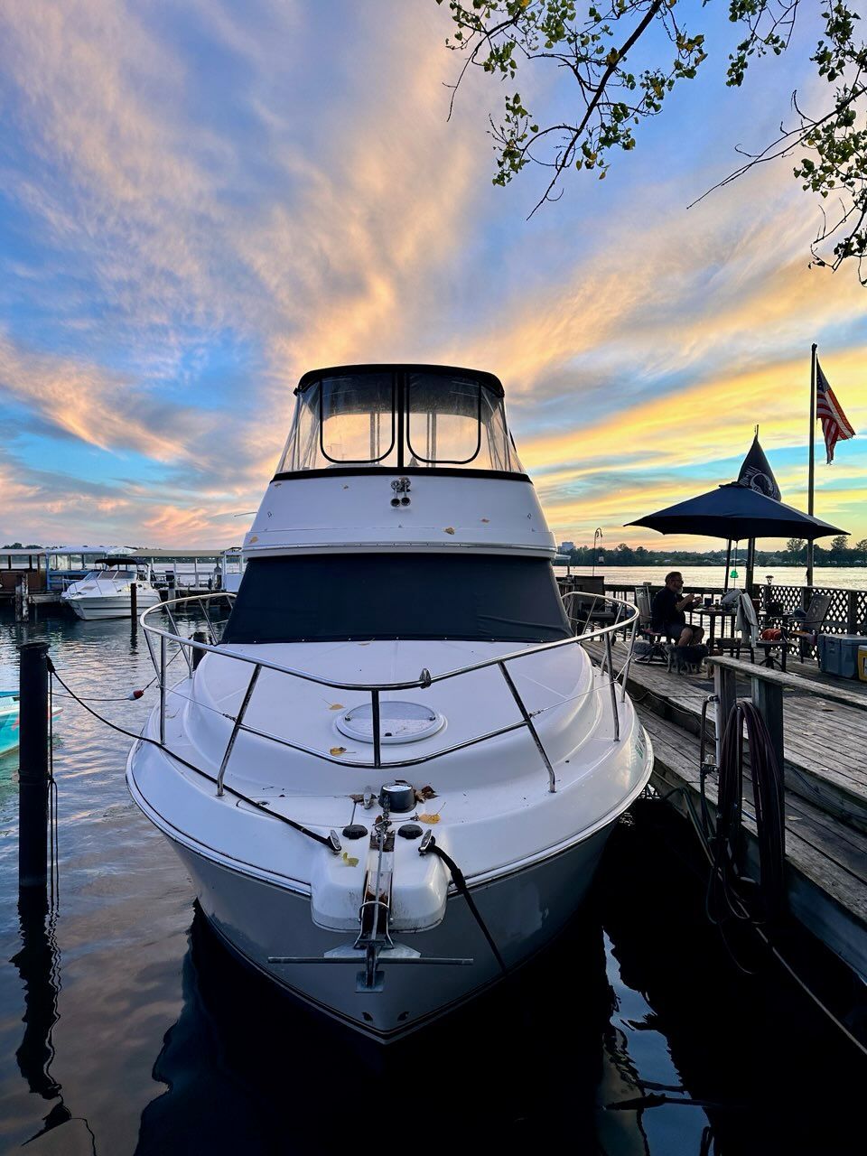 A Silverton 33 Convertible boat docked at sunset.