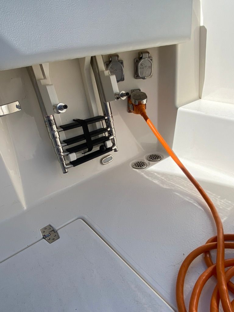 2023 Cobia 330 boat with power connection and ladder.