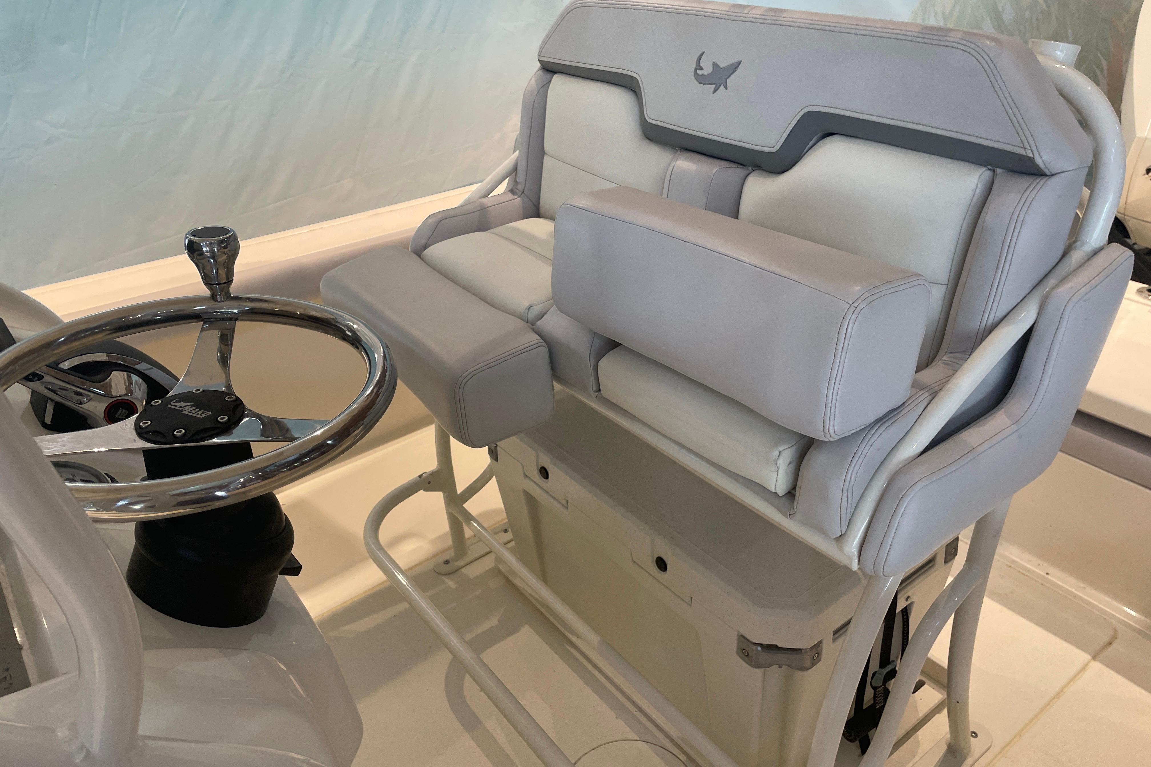 2026 Mako 226 Center Console boat interior with steering wheel and cushioned seating.