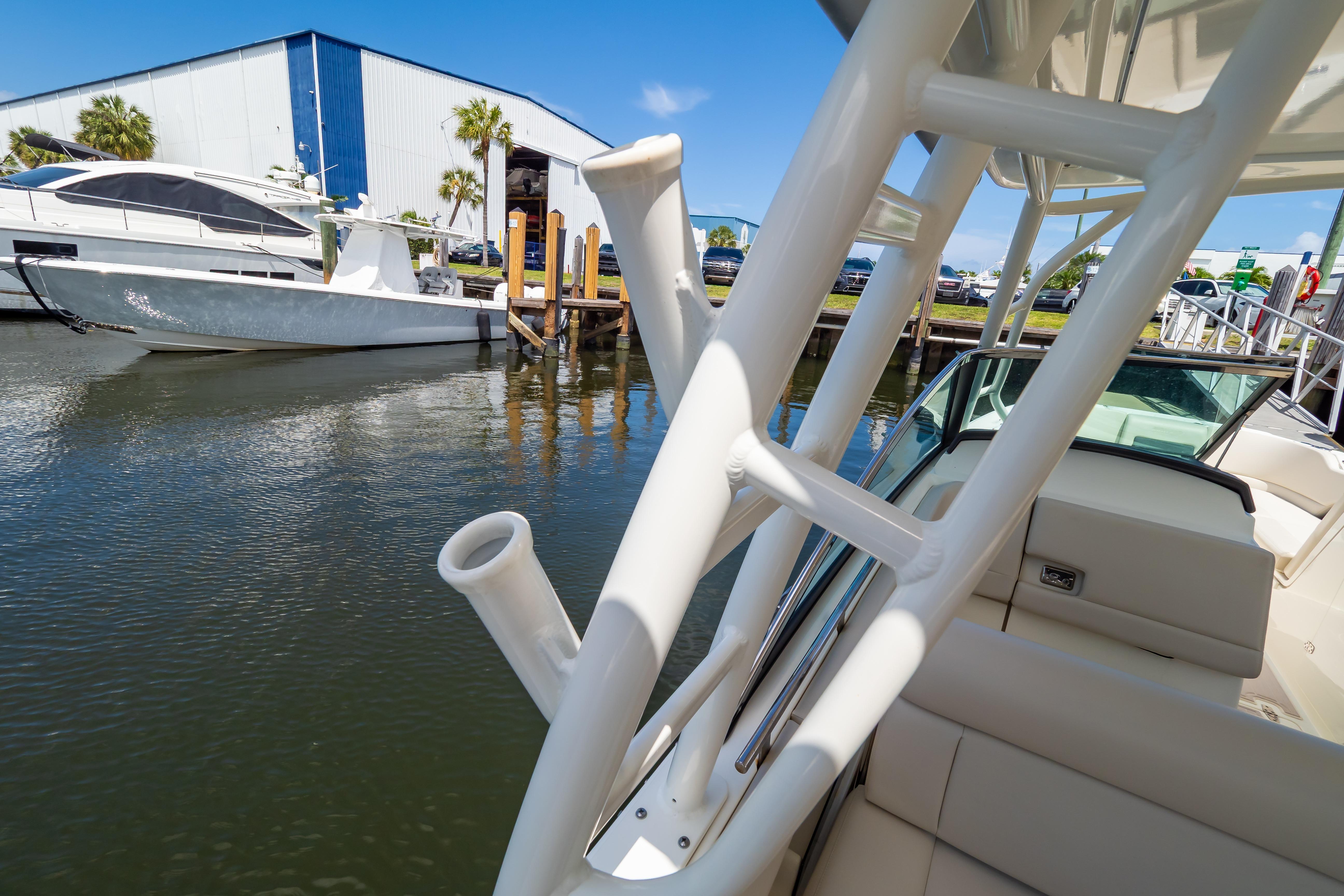 2019 Boston Whaler 270 Vantage docked near marina, showcasing sleek design and rod holders.