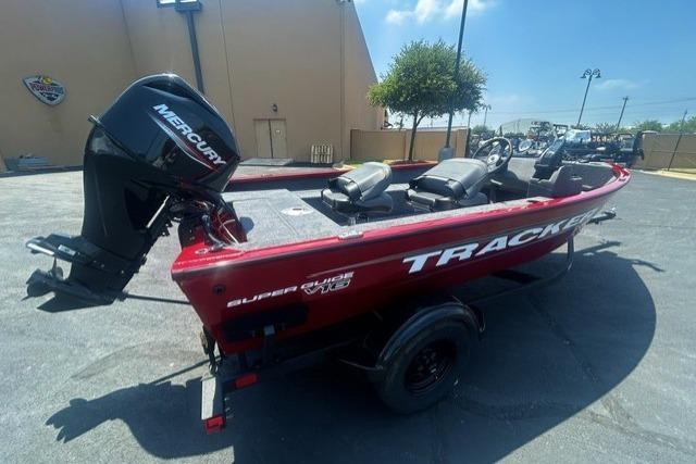 2026 Tracker Super Guide V-16 SC boat with Mercury engine, parked outdoors.