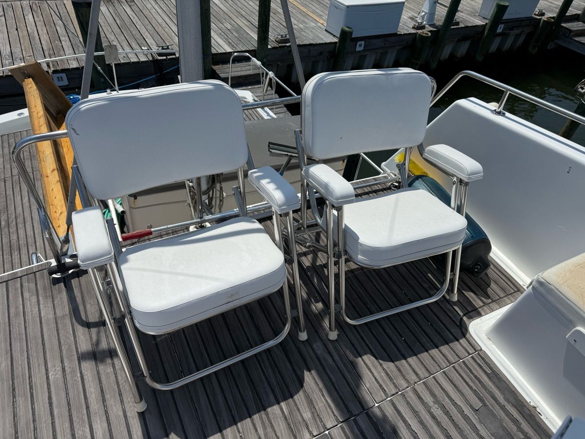 Two white chairs on a 1979 Prairie Boat Works trawler.