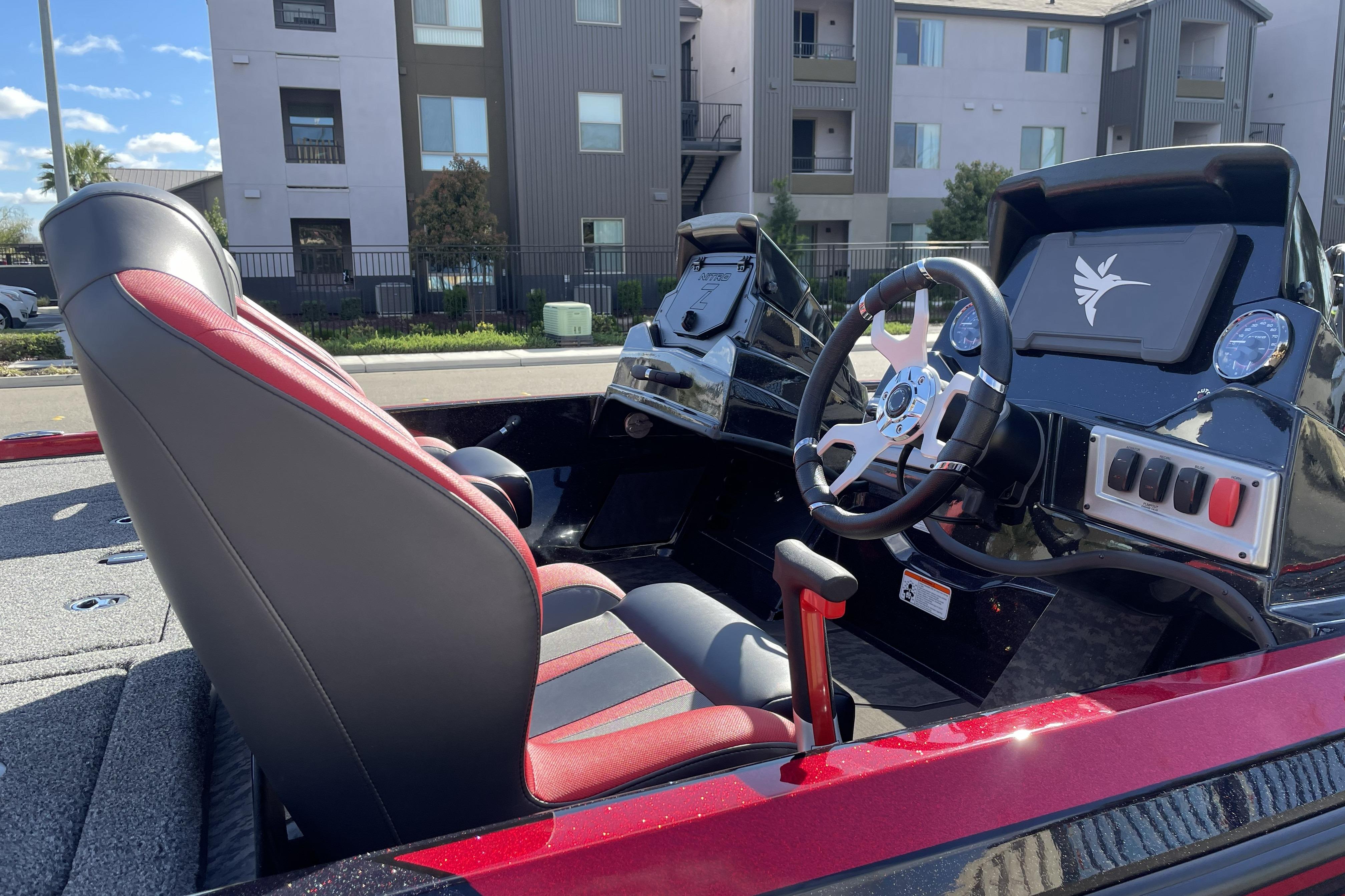 2026 Nitro Z19 XL boat interior with modern steering and red-accented seats.