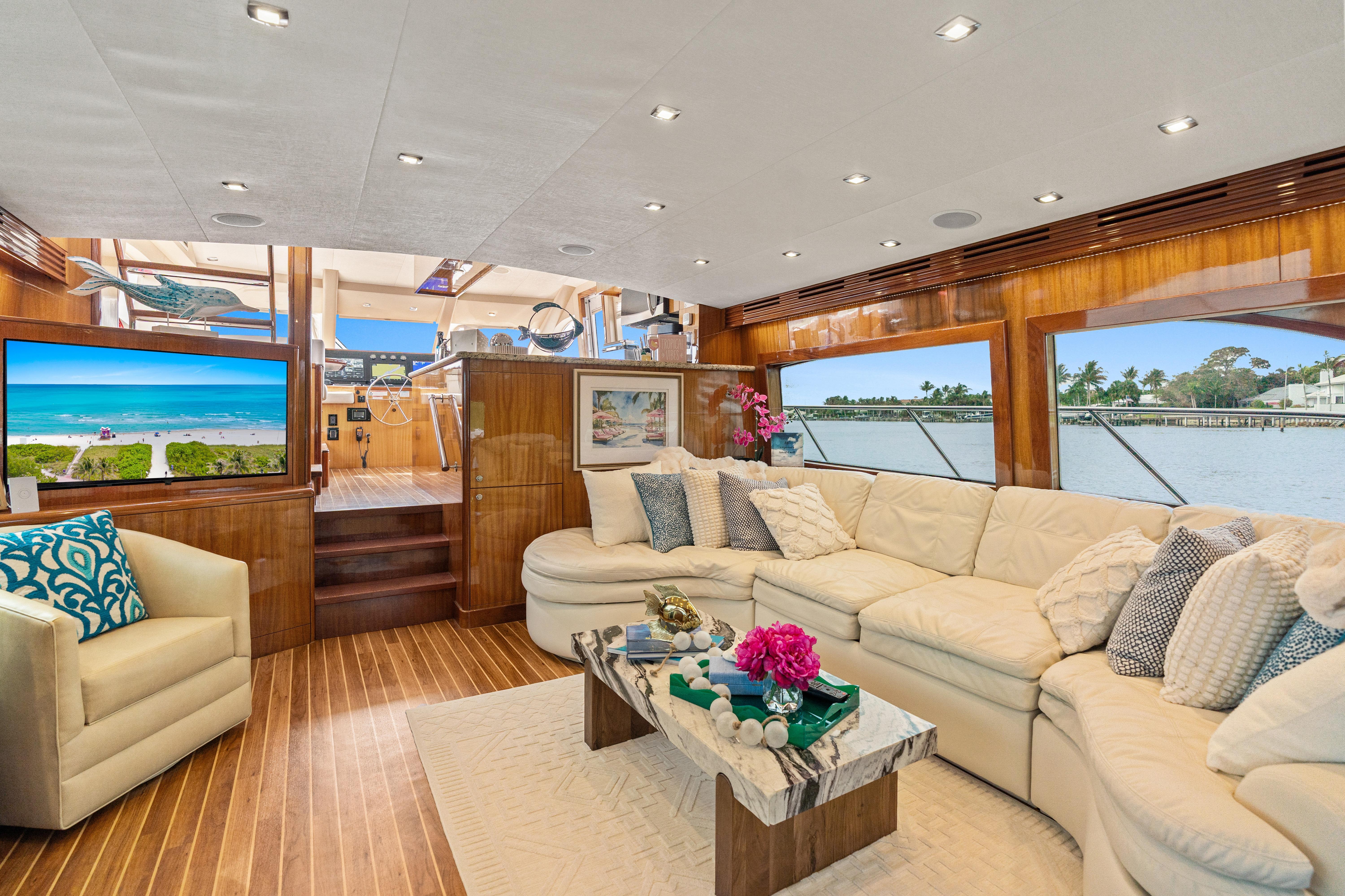 Luxurious interior of 2008 Hatteras 64 Motor Yacht with elegant seating and scenic views.