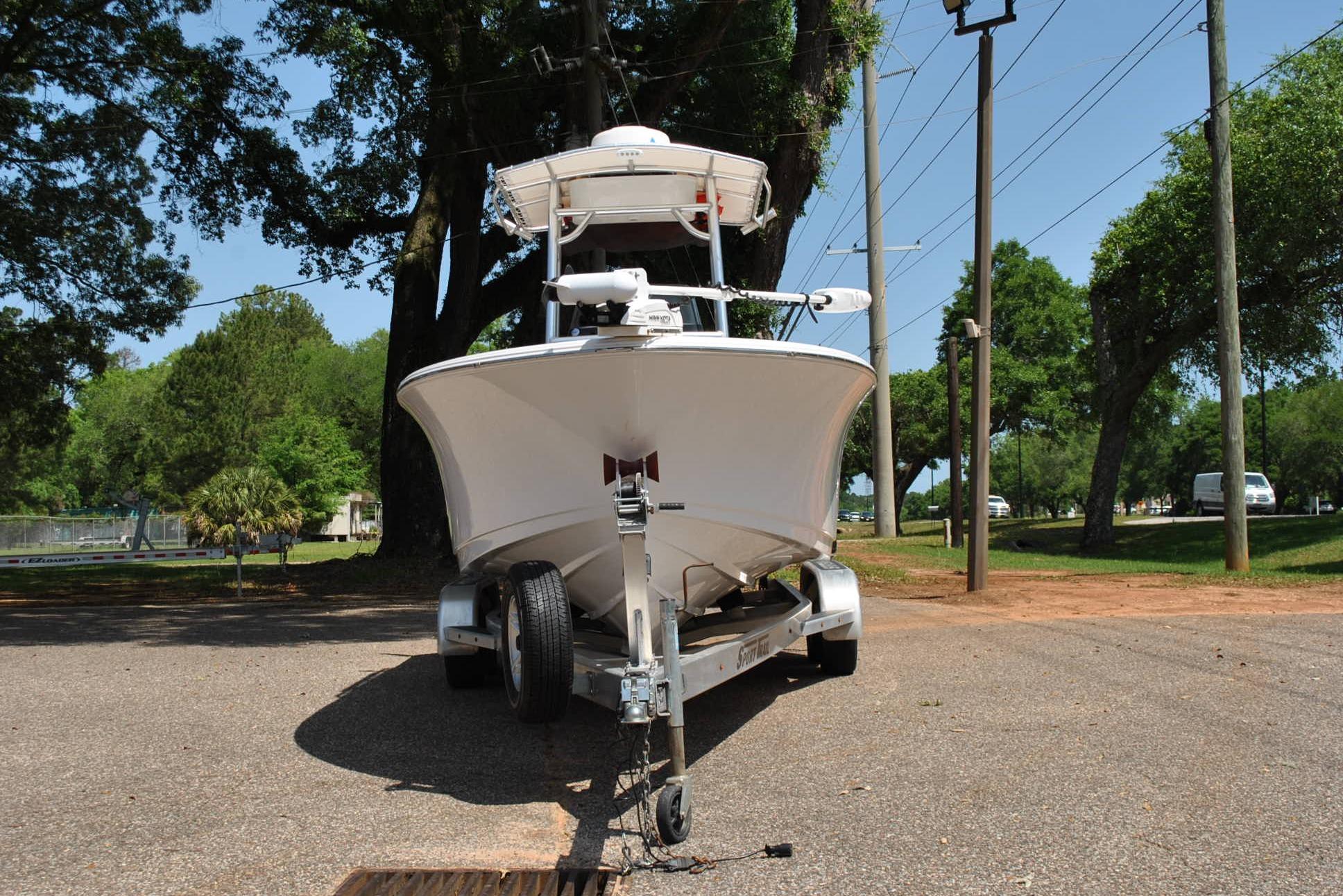 2020 Sportsman Open 232 Center Console boat on trailer, parked outdoors.
