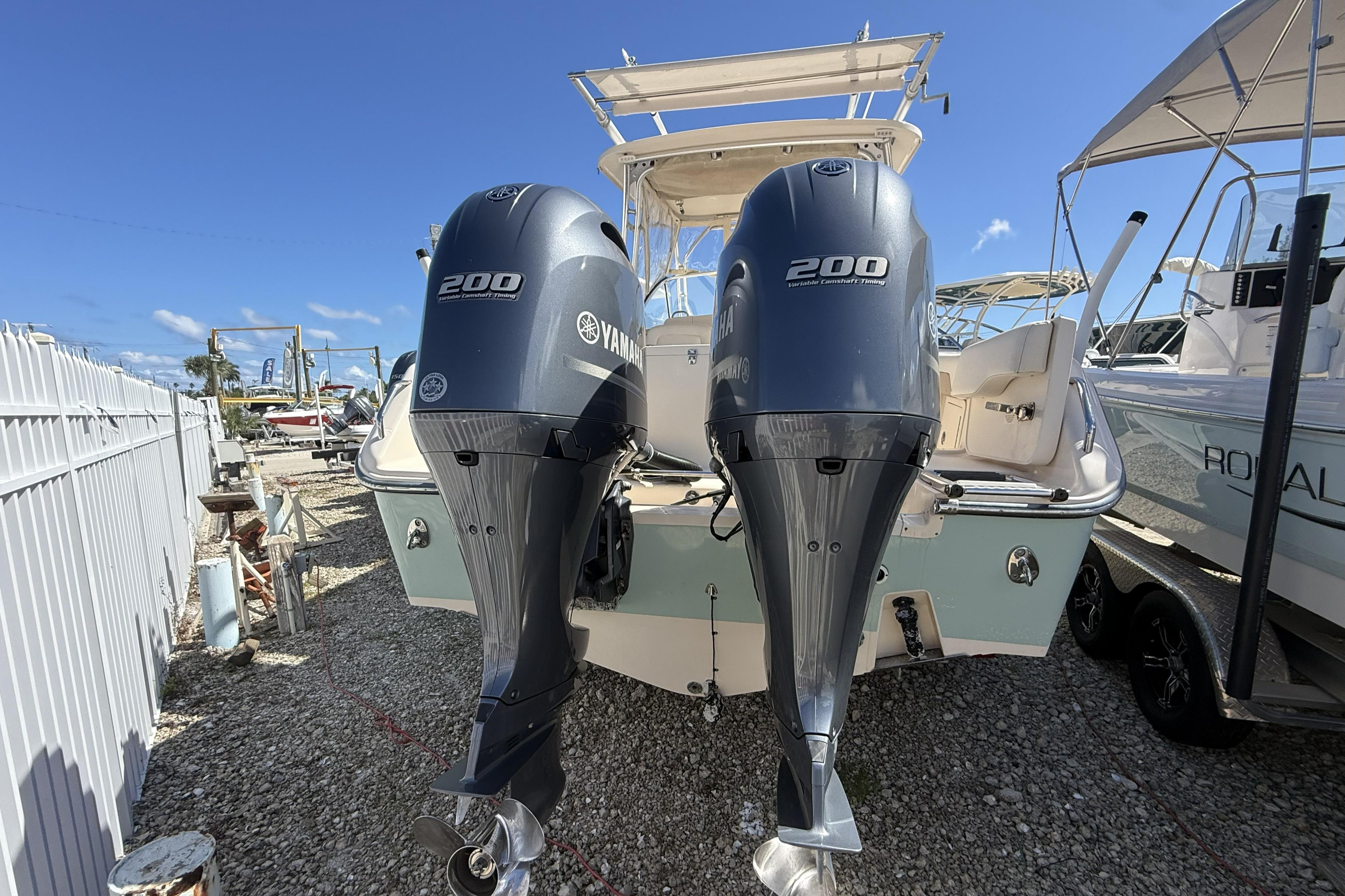 2014 Grady-White Freedom 275 boat with twin Yamaha 200 engines, docked outdoors.