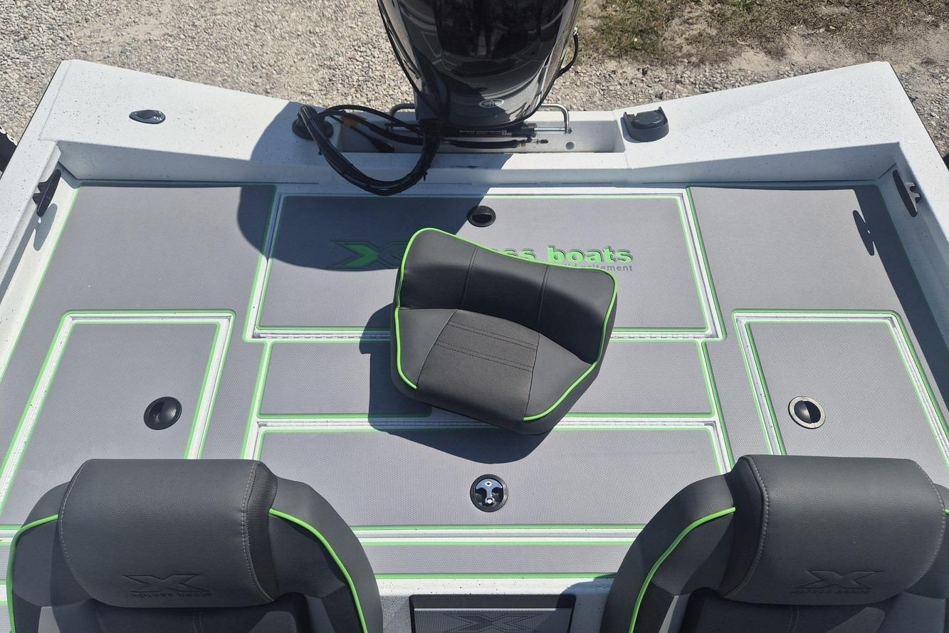 2026 Xpress H18 boat interior with gray and green seating and deck design.