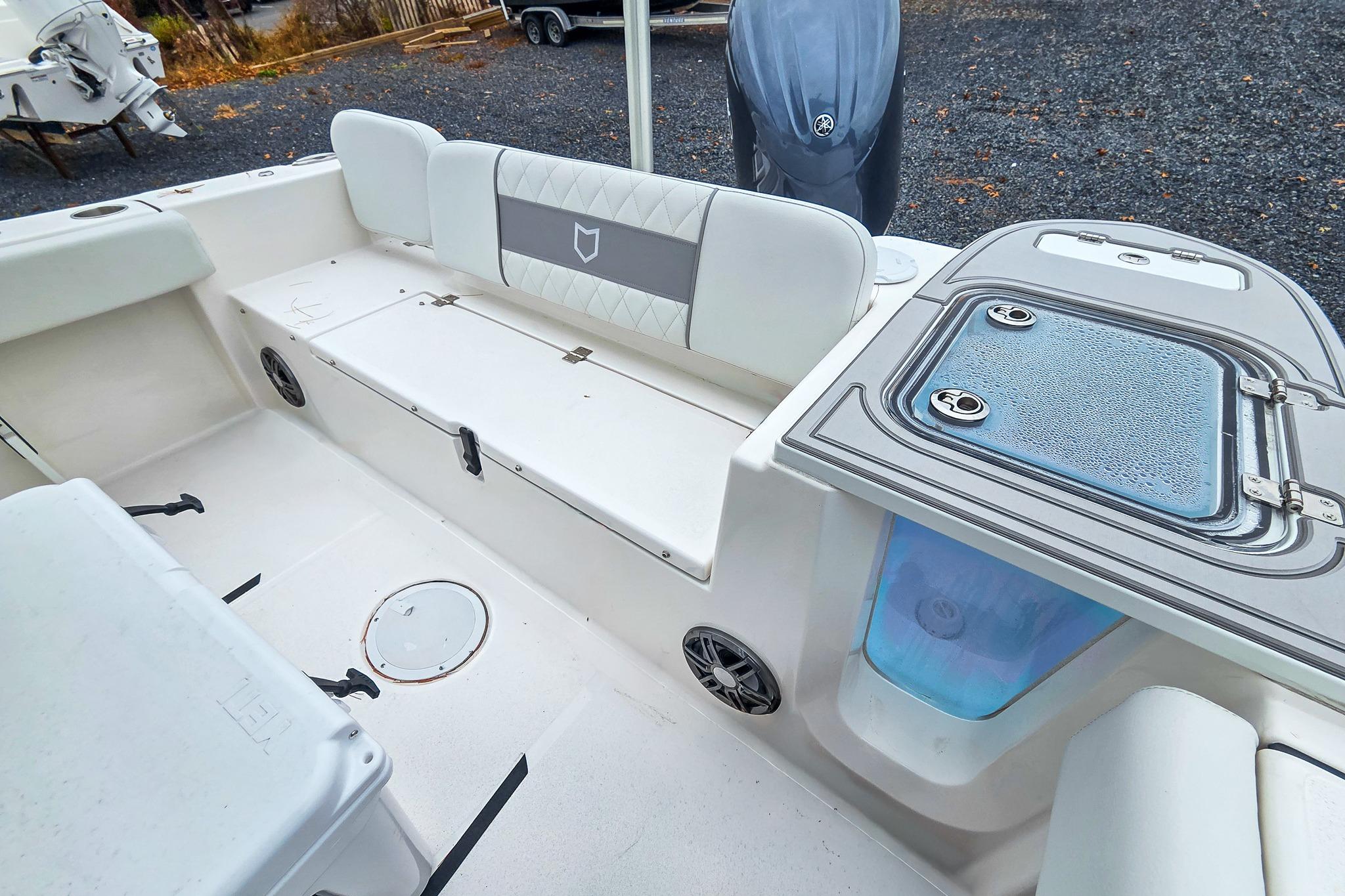 2026 Sea Fox 228 Commander boat interior with seating and storage compartments.