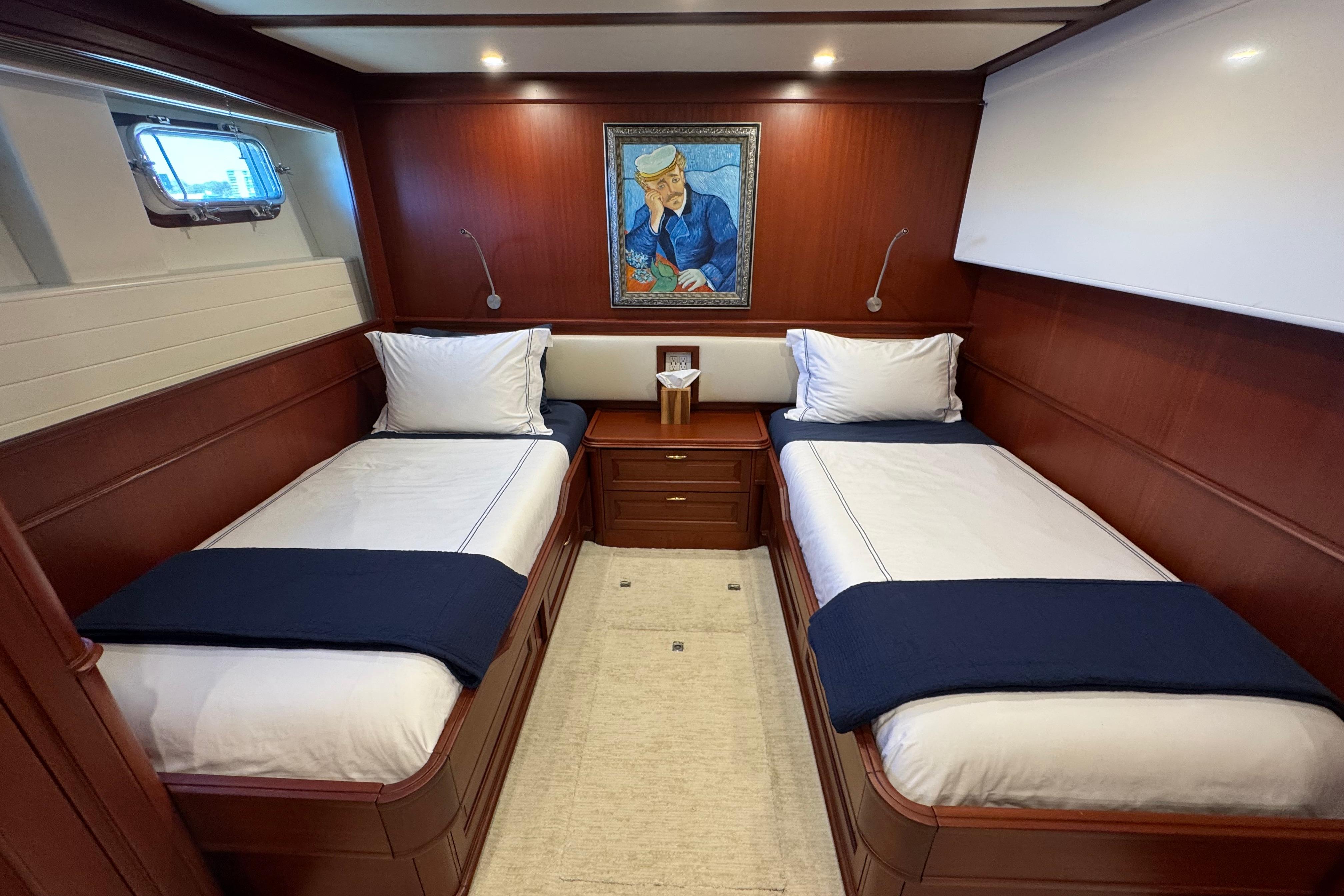 Luxurious yacht cabin with twin beds, elegant wood paneling, and nautical artwork, Doogersbank Vipack 2001.