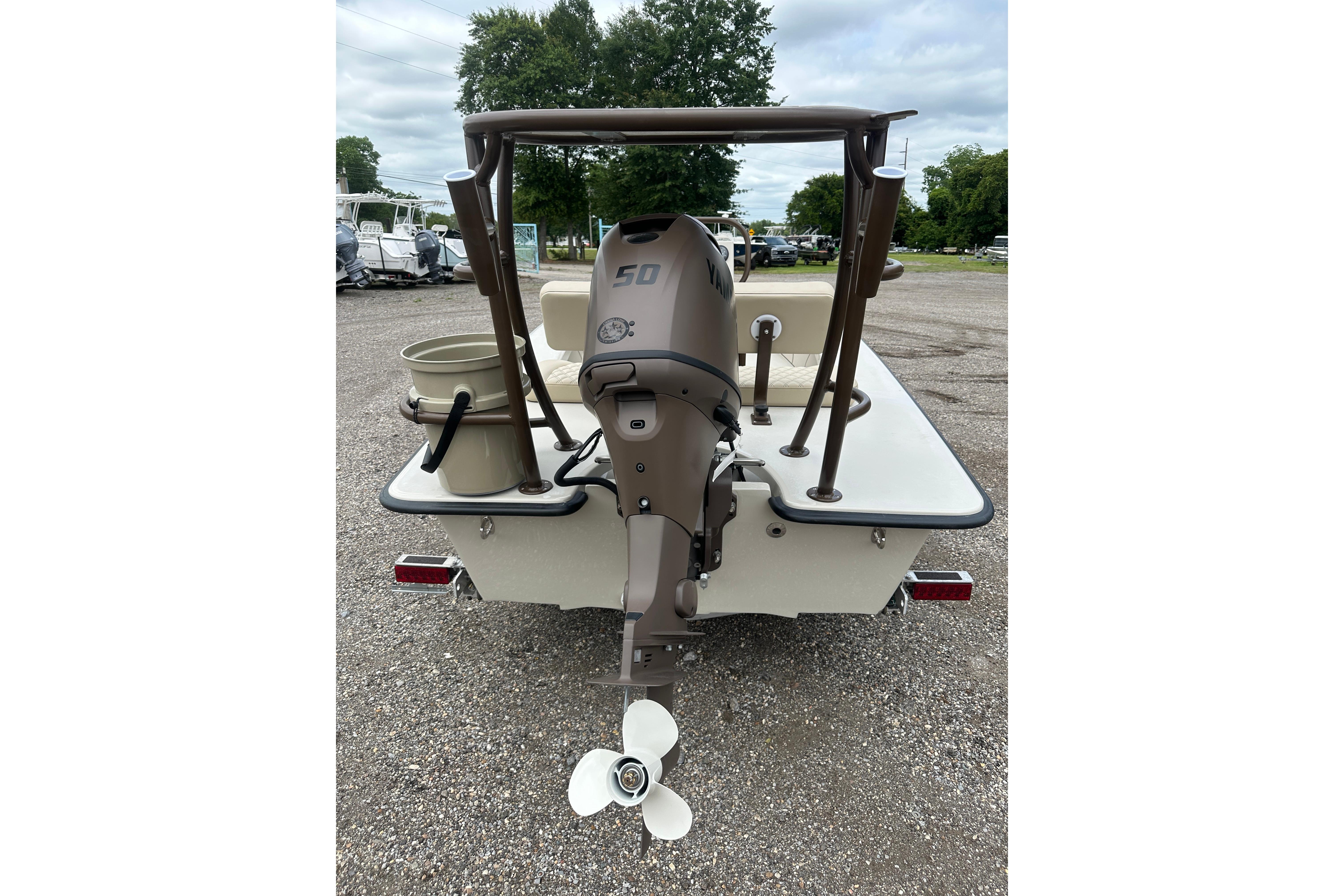 2027 Delta Boatworks Delta D18 with outboard motor, rear view in a parking area.