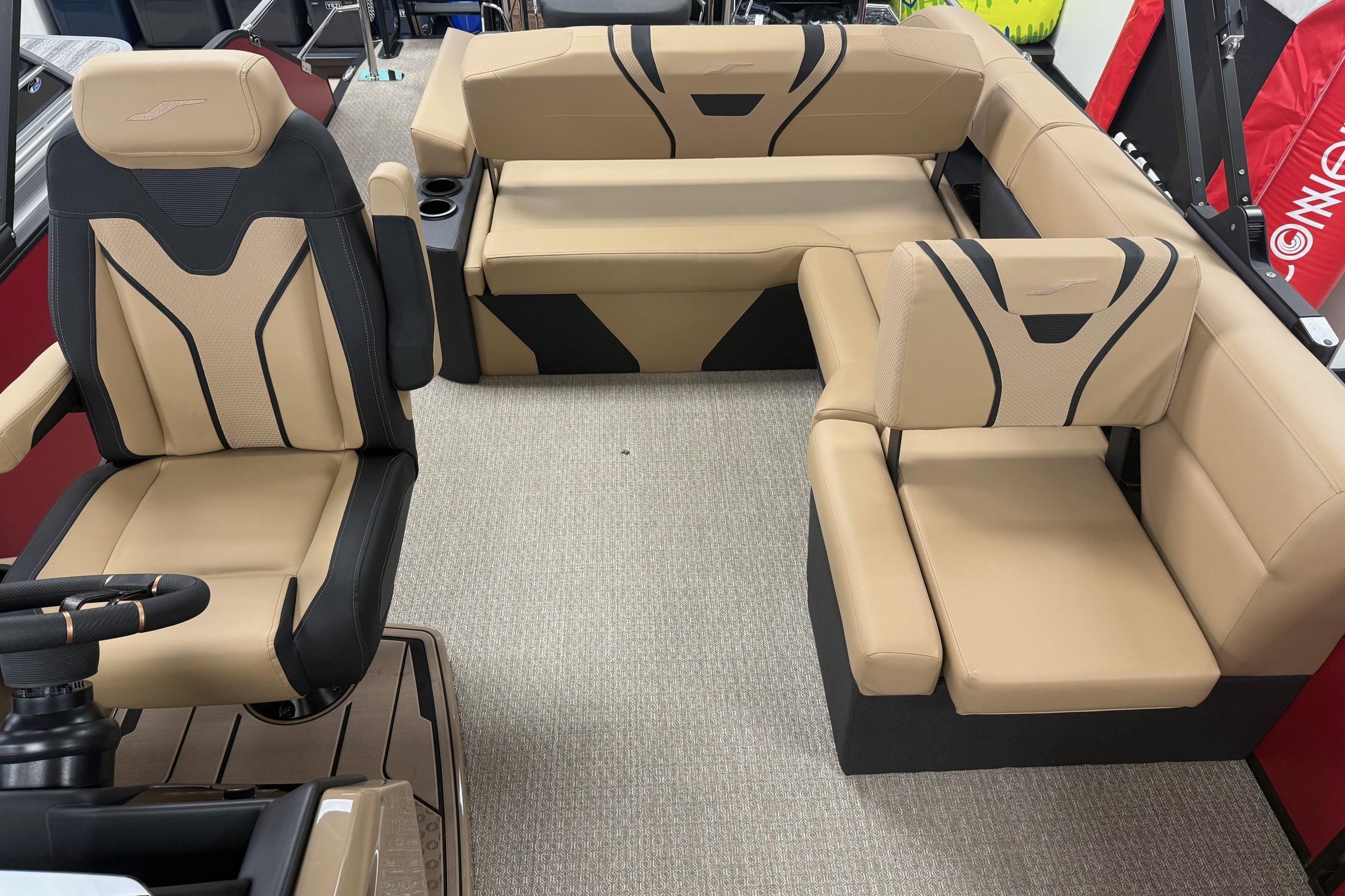 Luxurious interior of 2026 Evotti 725CS boat with beige and black seating.
