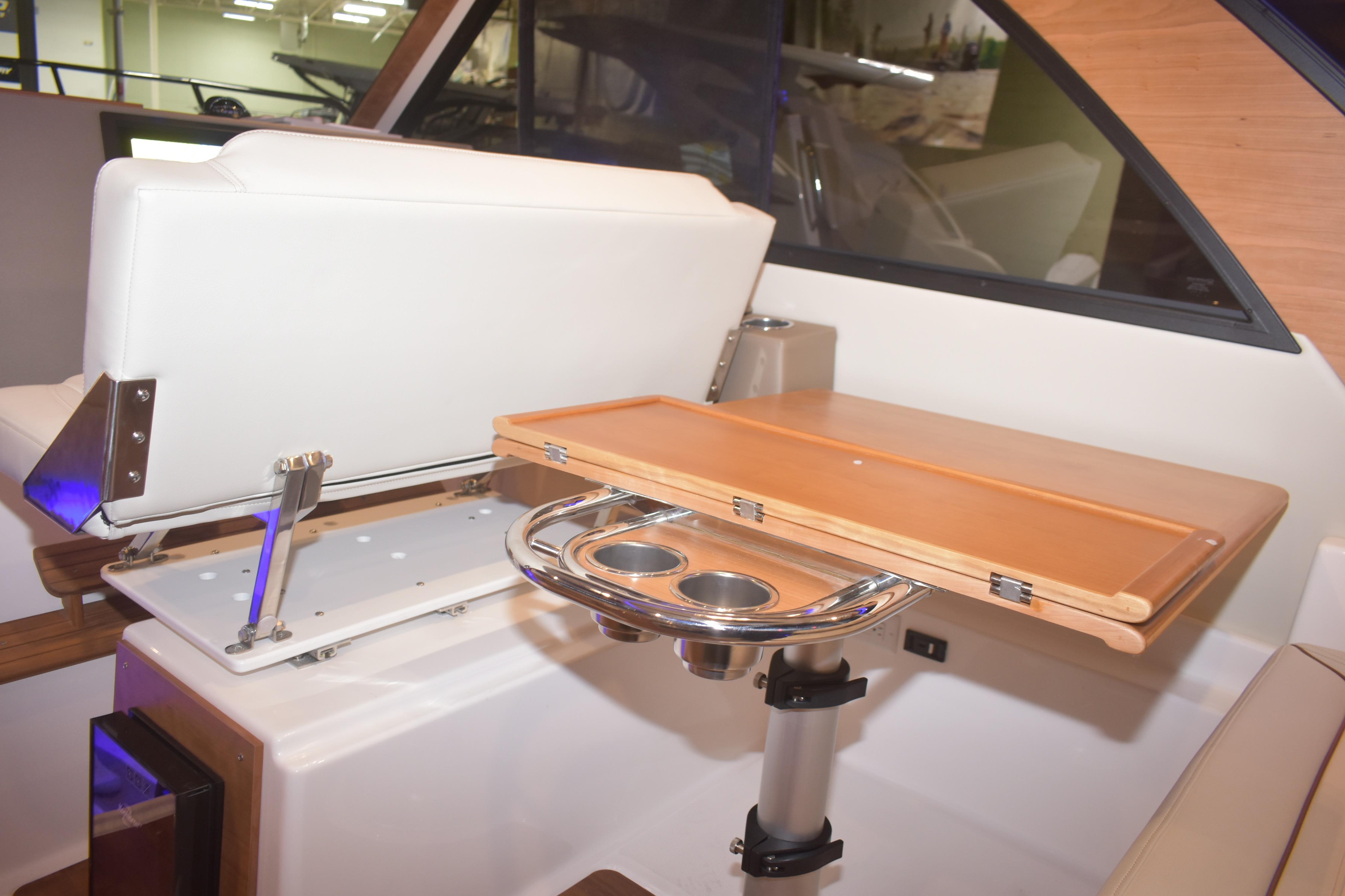 Interior of 2026 Cutwater C-32 CB boat featuring a foldable table and seating area.