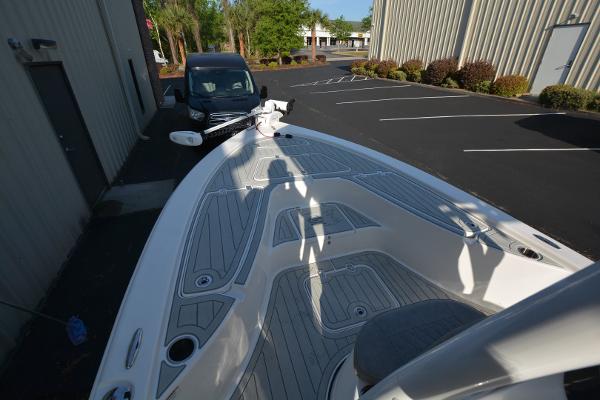 2021 Sea Pro 228 Bay boat parked near a building, showcasing its deck design.