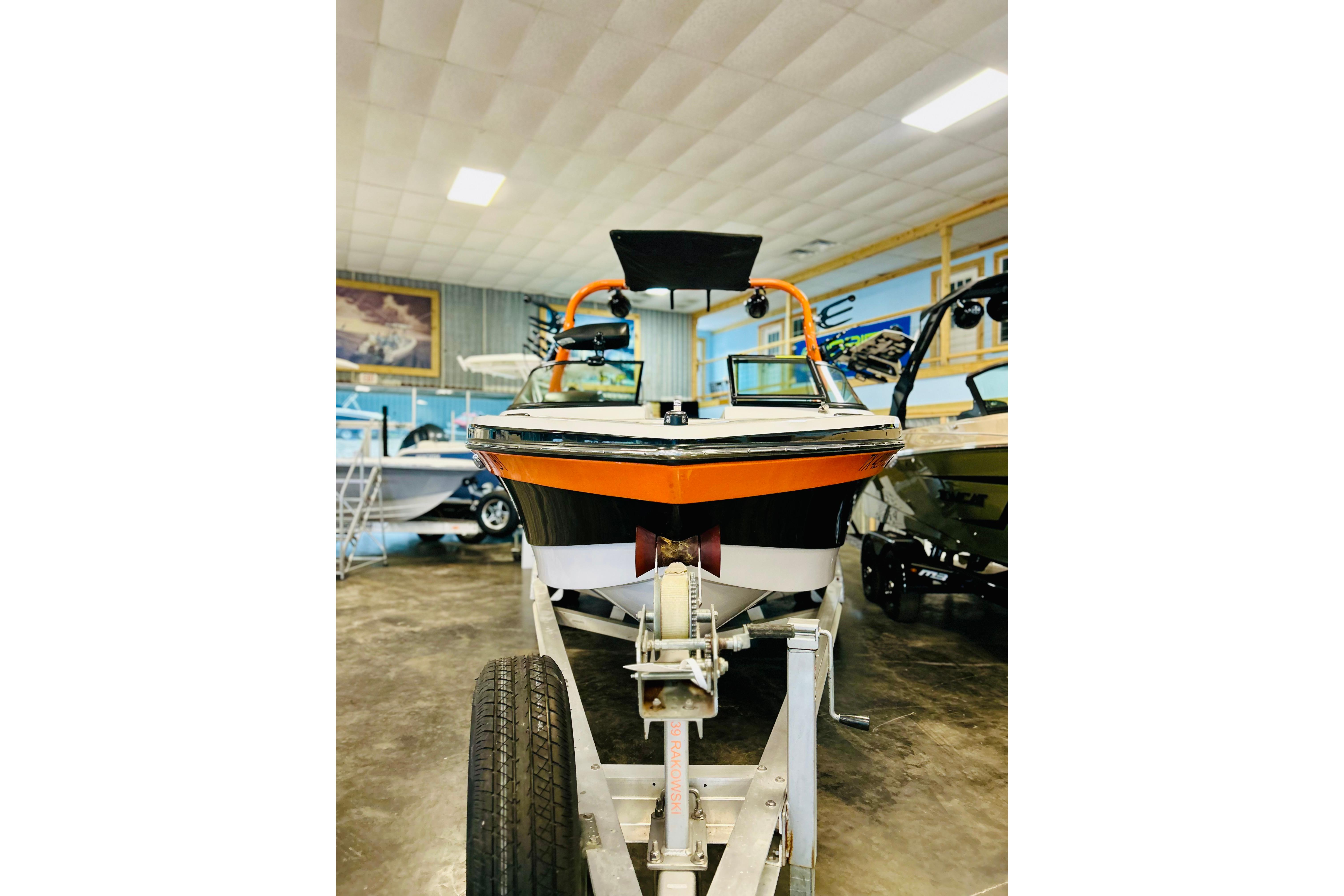 2013 Nautique Super Air Nautique 230 boat on trailer in showroom.