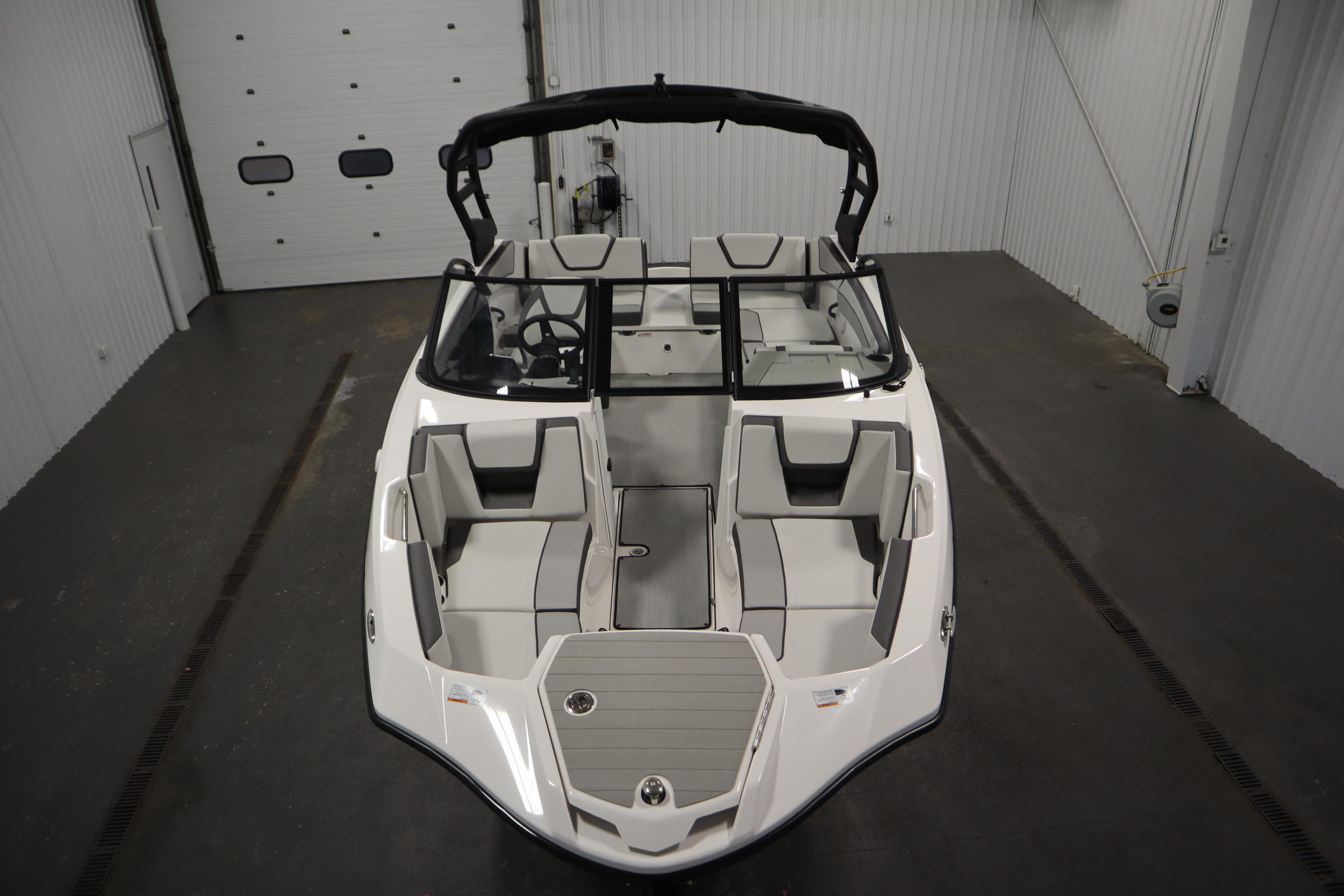 2026 Yamaha Boats AR220 in a showroom, showcasing sleek design and spacious seating.