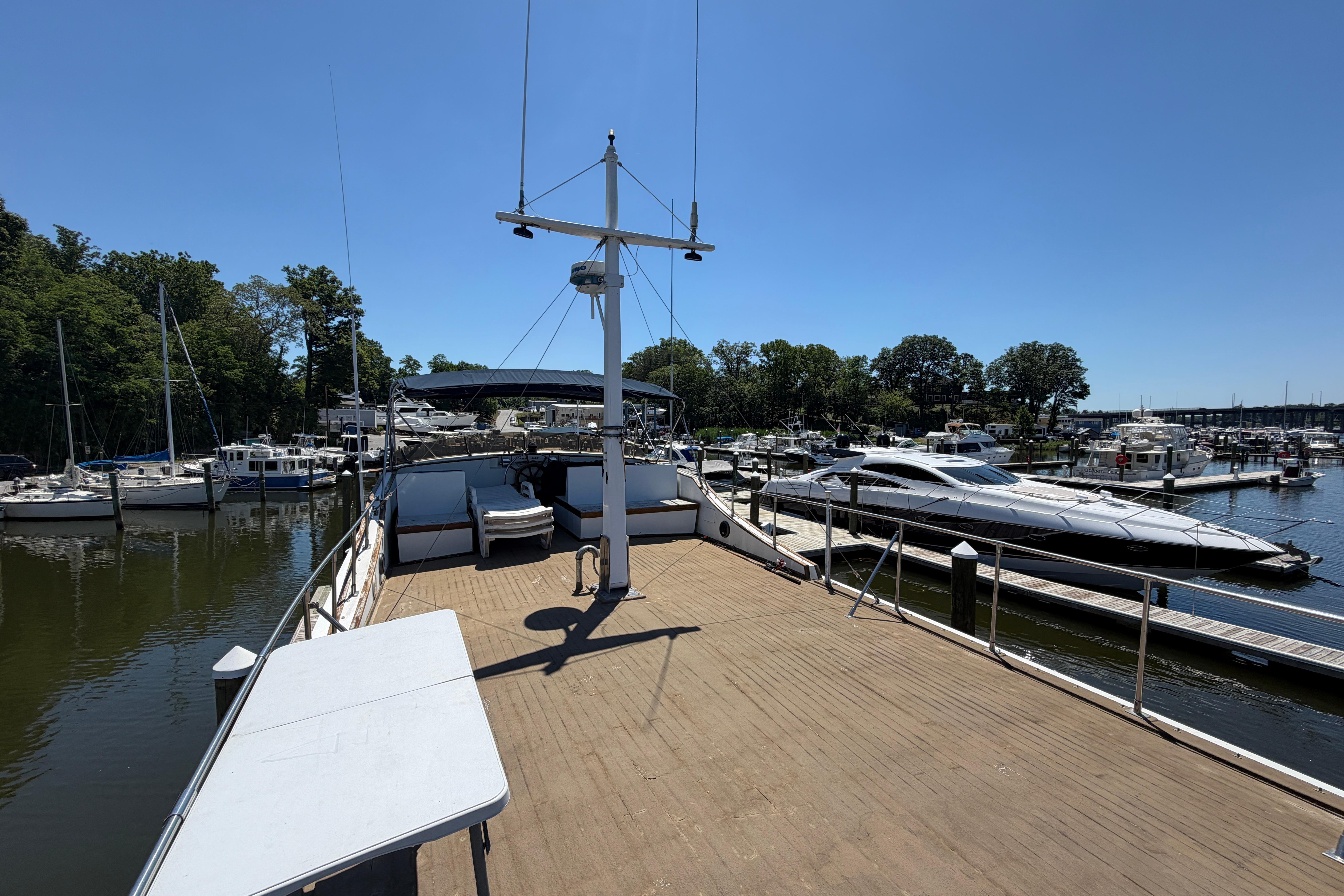 1981 Marine Trader 50 yacht docked at a marina, surrounded by other boats.