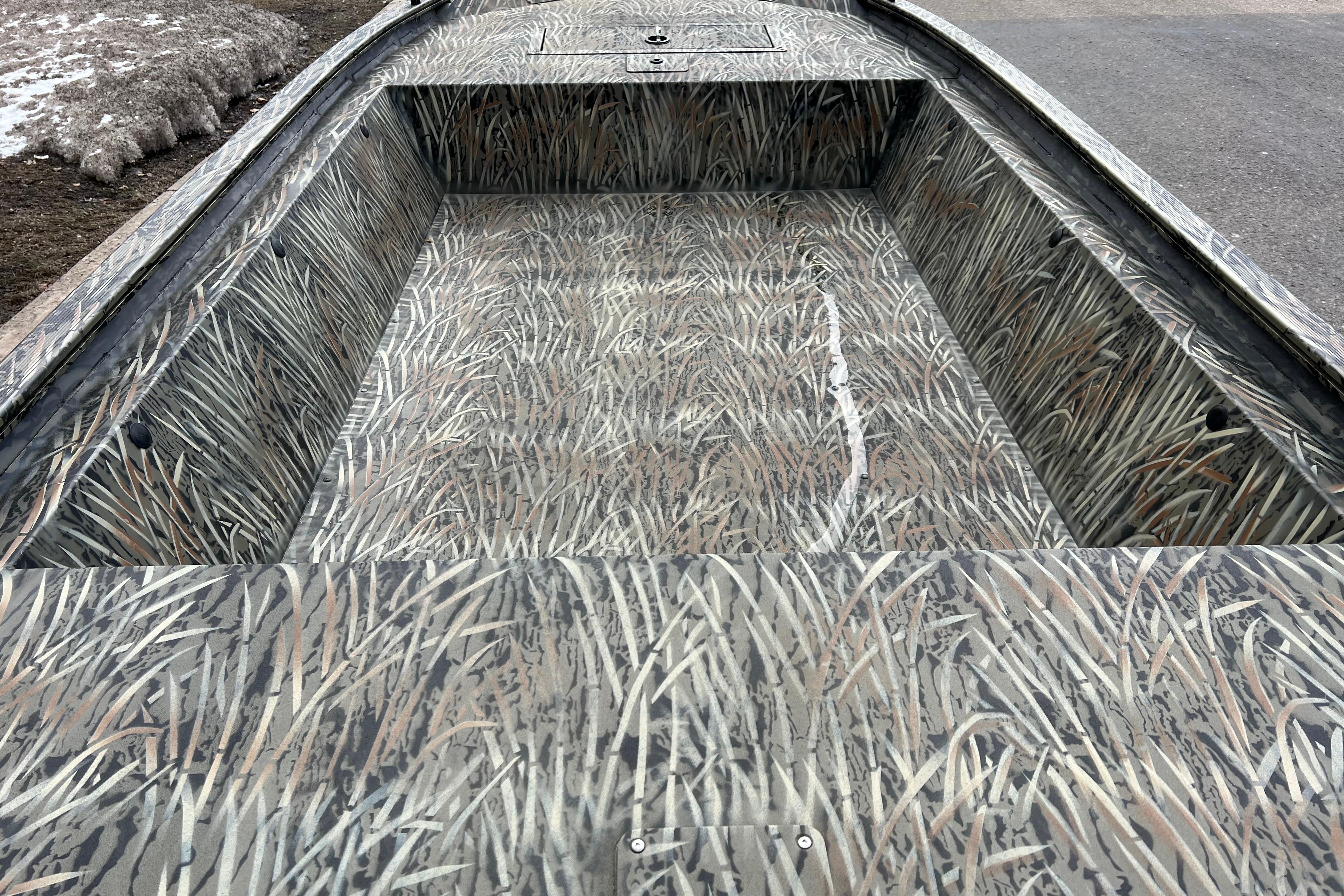 2026 Tracker Grizzly 1648 Utility boat with camouflage interior design.