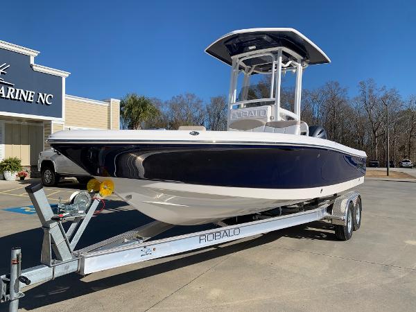 2024 Robalo 226 Cayman boat on a trailer at a dealership.
