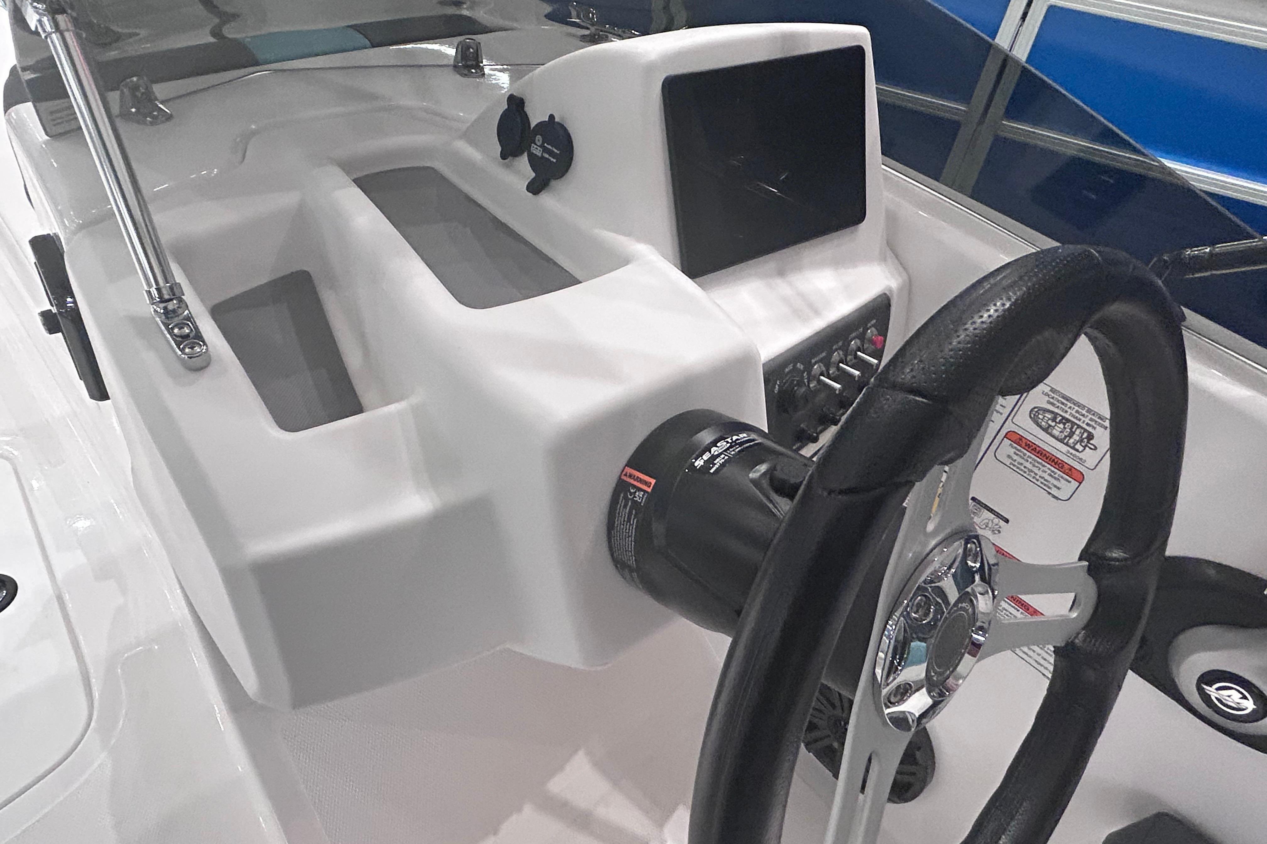2026 Tahoe T18 boat dashboard with steering wheel and control panel.