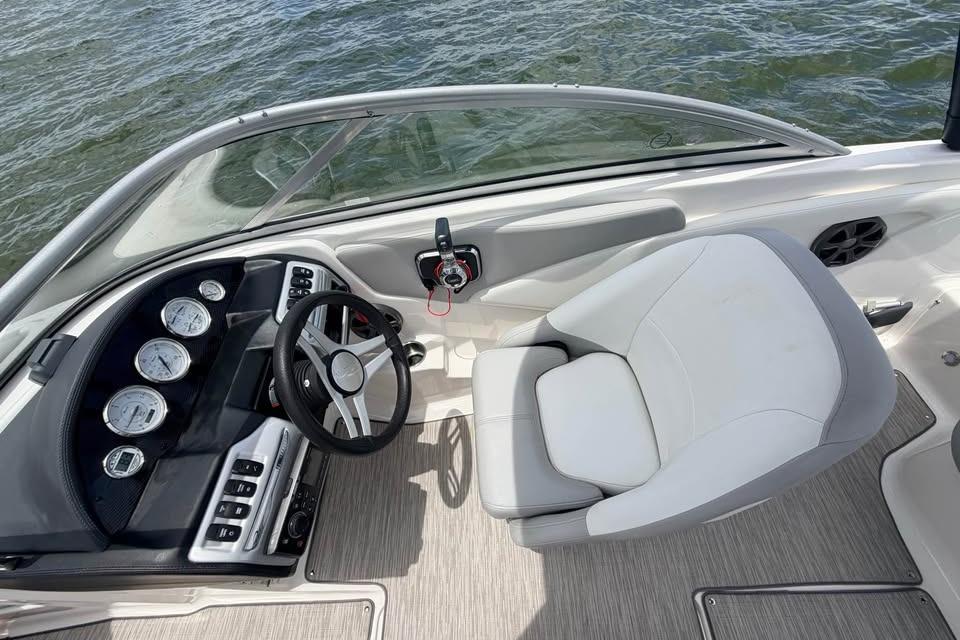 2019 Regal 1900 ES Bowrider cockpit with steering wheel and gauges, on water.