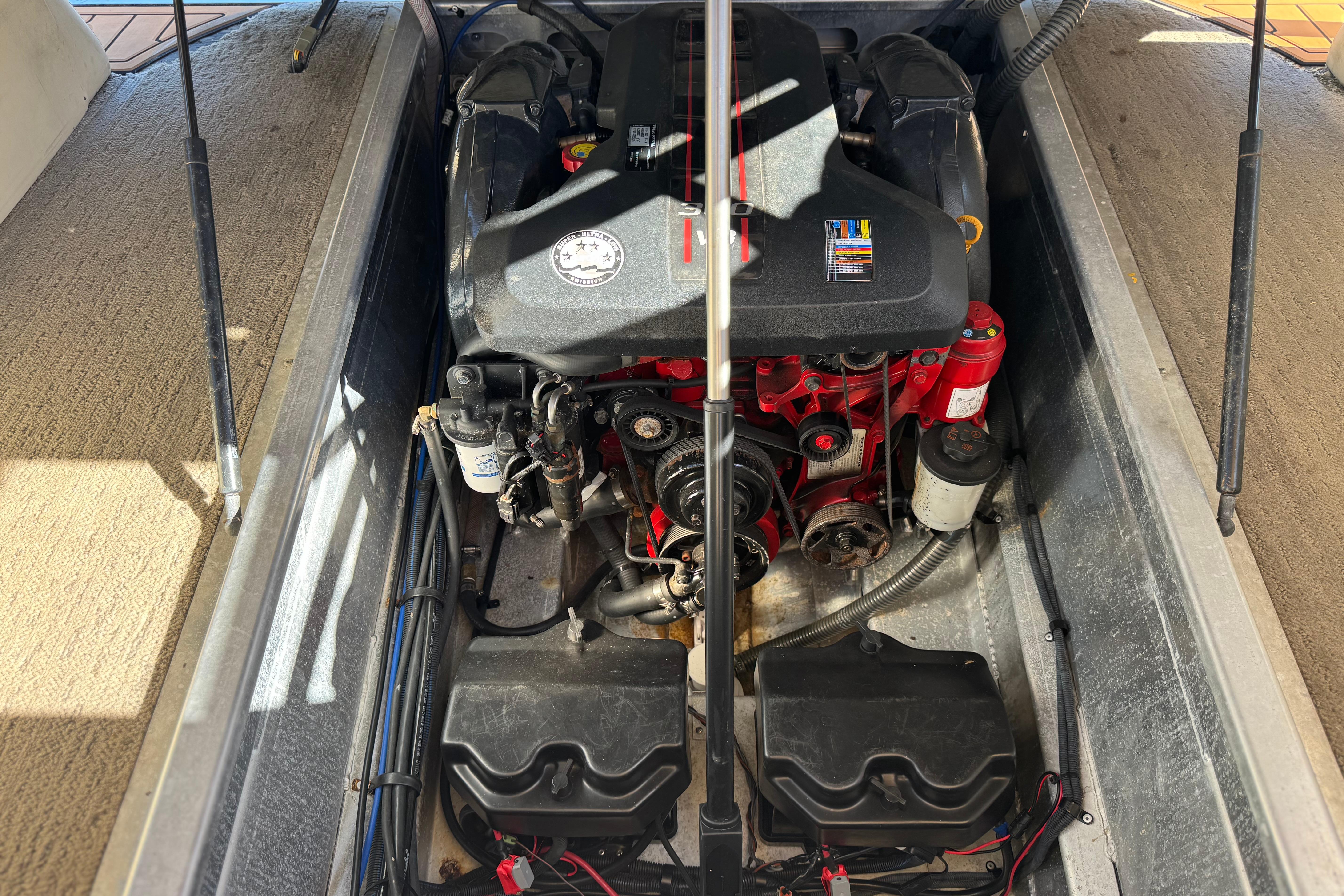 Engine compartment of a 2013 Bennington 2575QCW I/O boat, showcasing detailed mechanical components.
