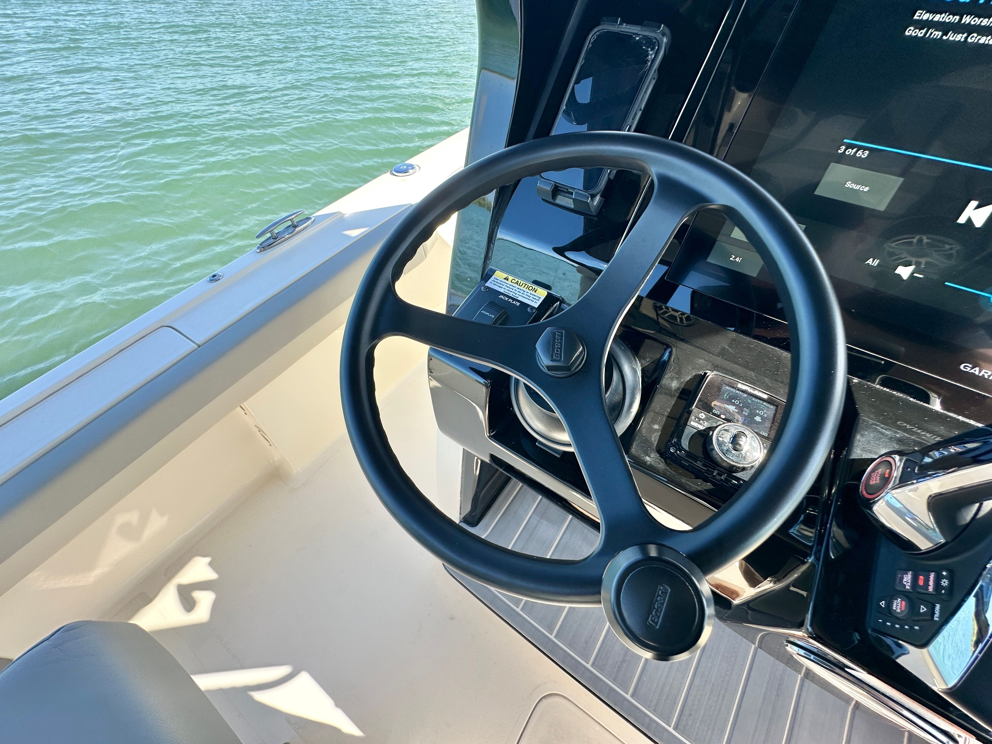 The image shows the helm of a 2024 Scout 281 XSS boat on the water.