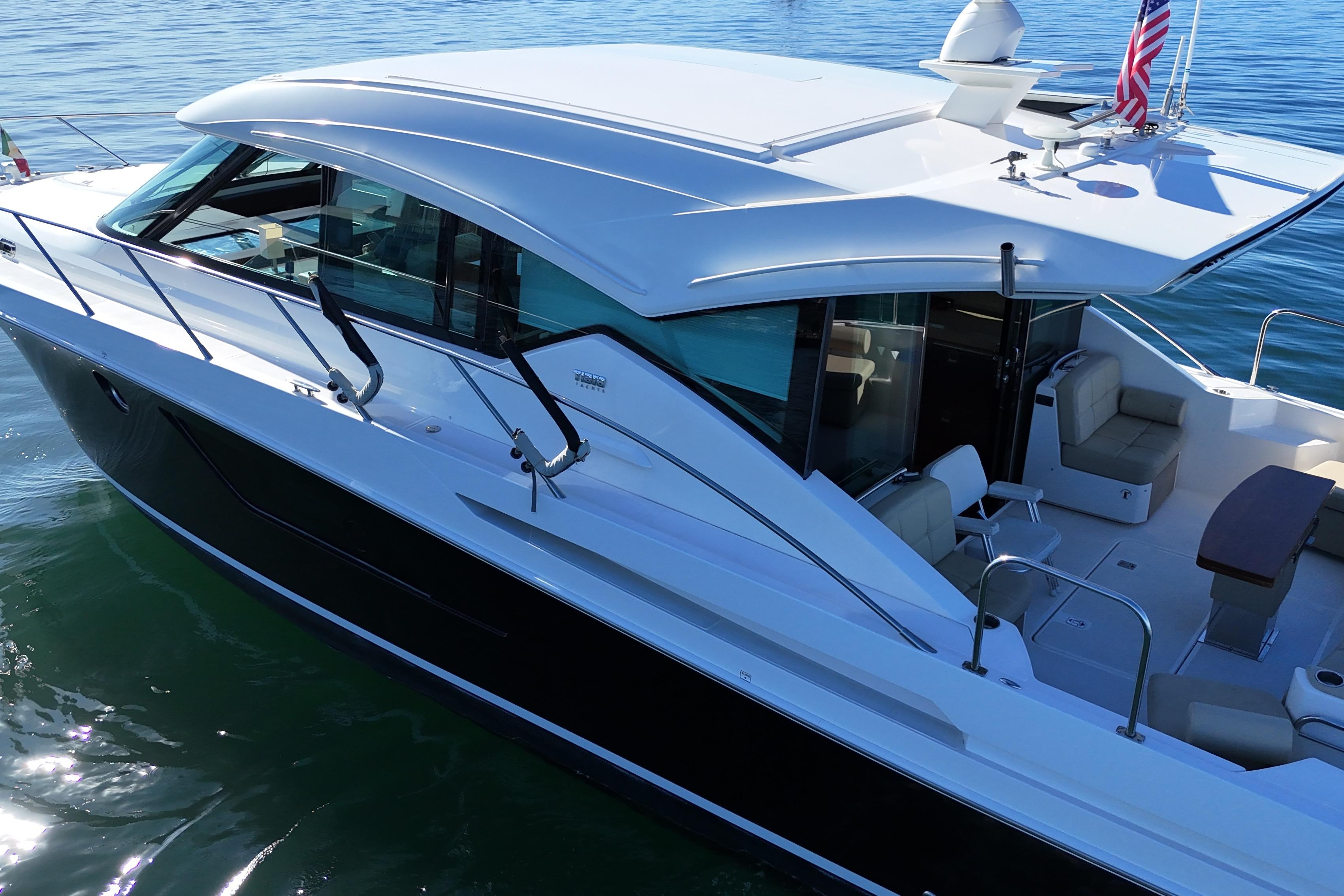 2016 Tiara Yachts 50 Coupe on calm water, showcasing sleek design and spacious deck.