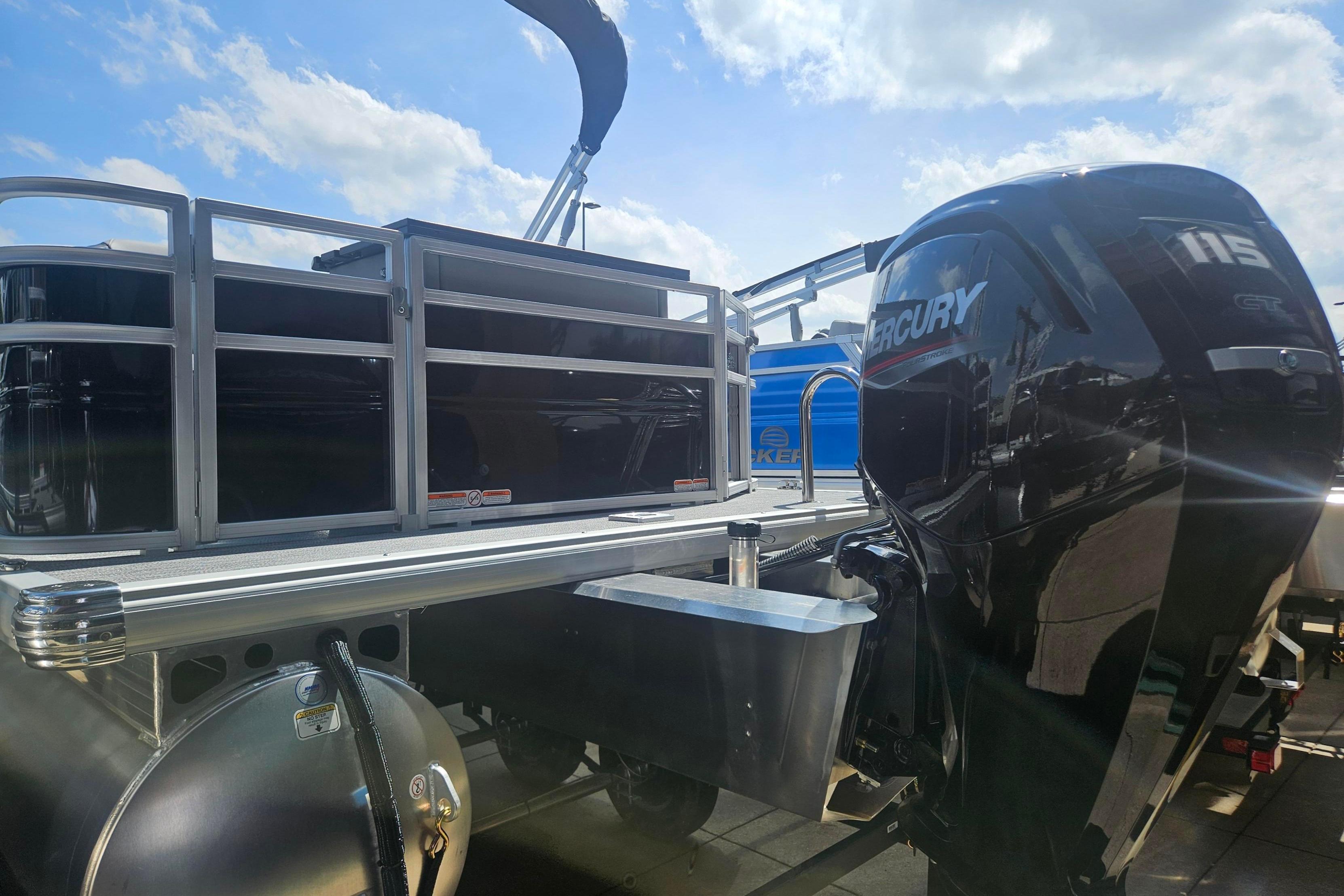 2026 Sun Tracker SportFish 20 DLX pontoon boat with Mercury 115 engine under a sunny sky.