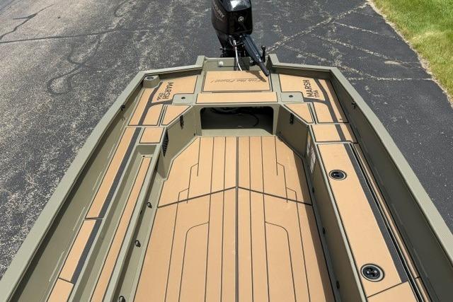 2026 Tracker Grizzly 1756 T Marsh boat deck, featuring tan and green design.