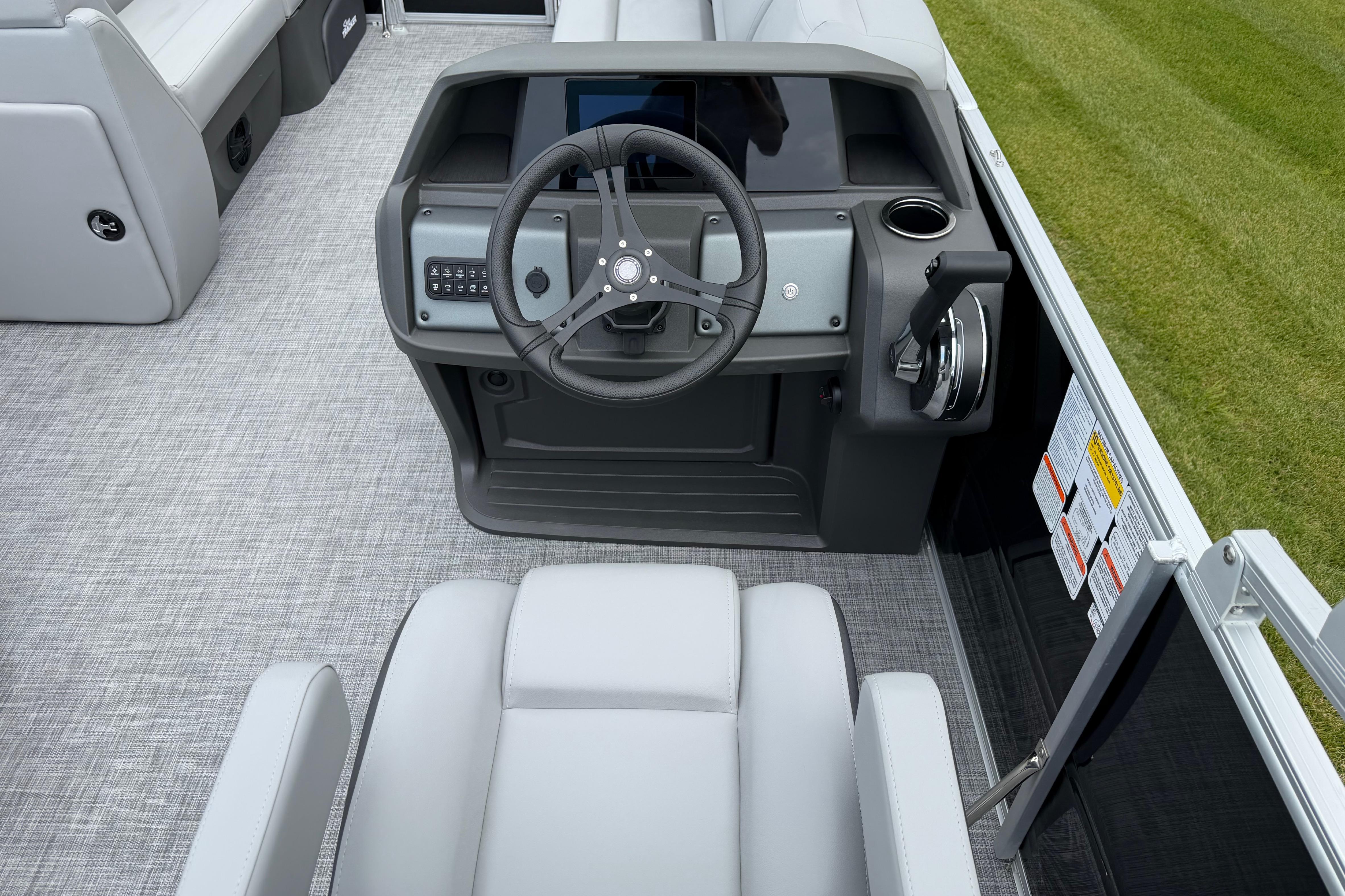 2026 Sun Tracker Party Barge 20 DLX helm with steering wheel and controls.
