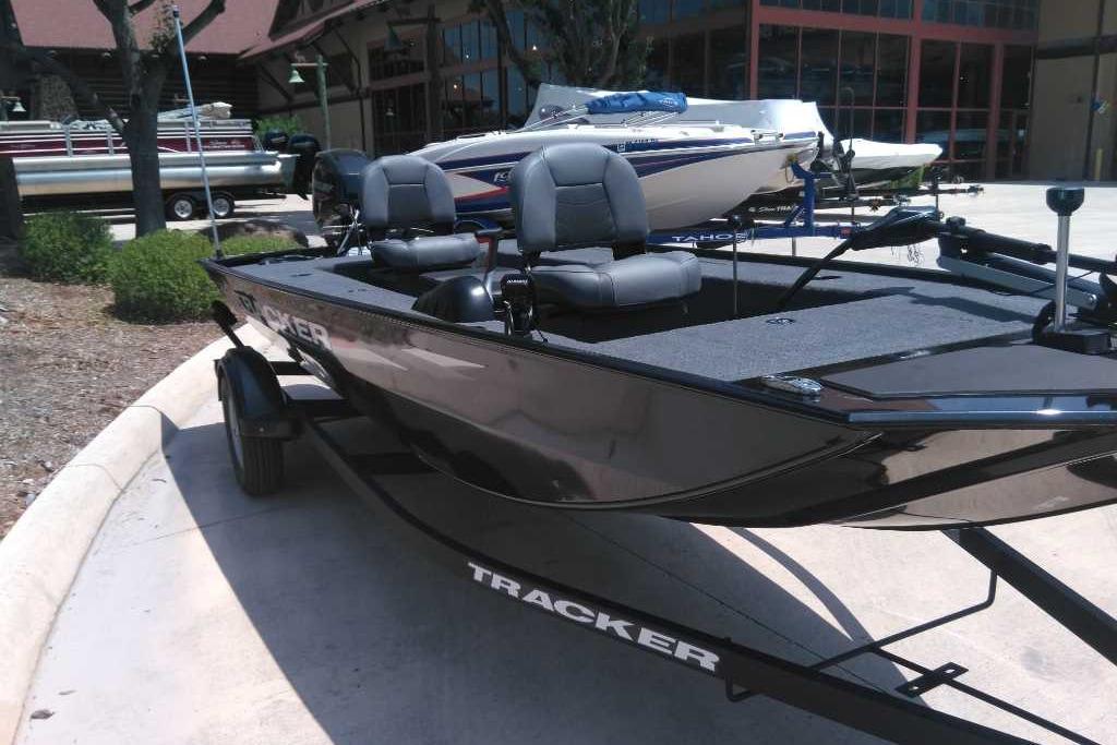 2025 Tracker Panfish 17 boat on trailer, parked outdoors near other boats.