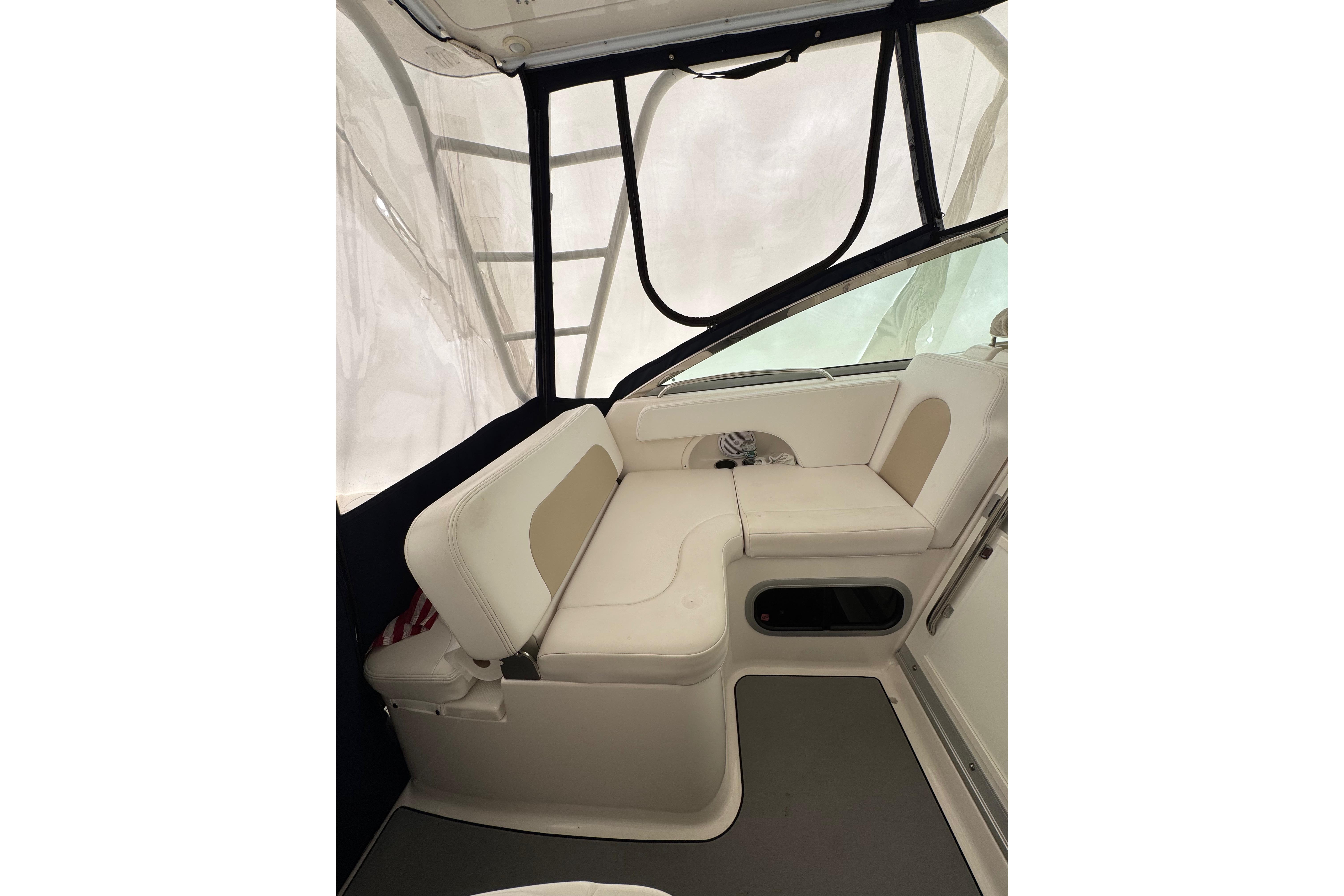 2018 Robalo R305 Walkaround interior seating area with cushioned benches and protective canopy.