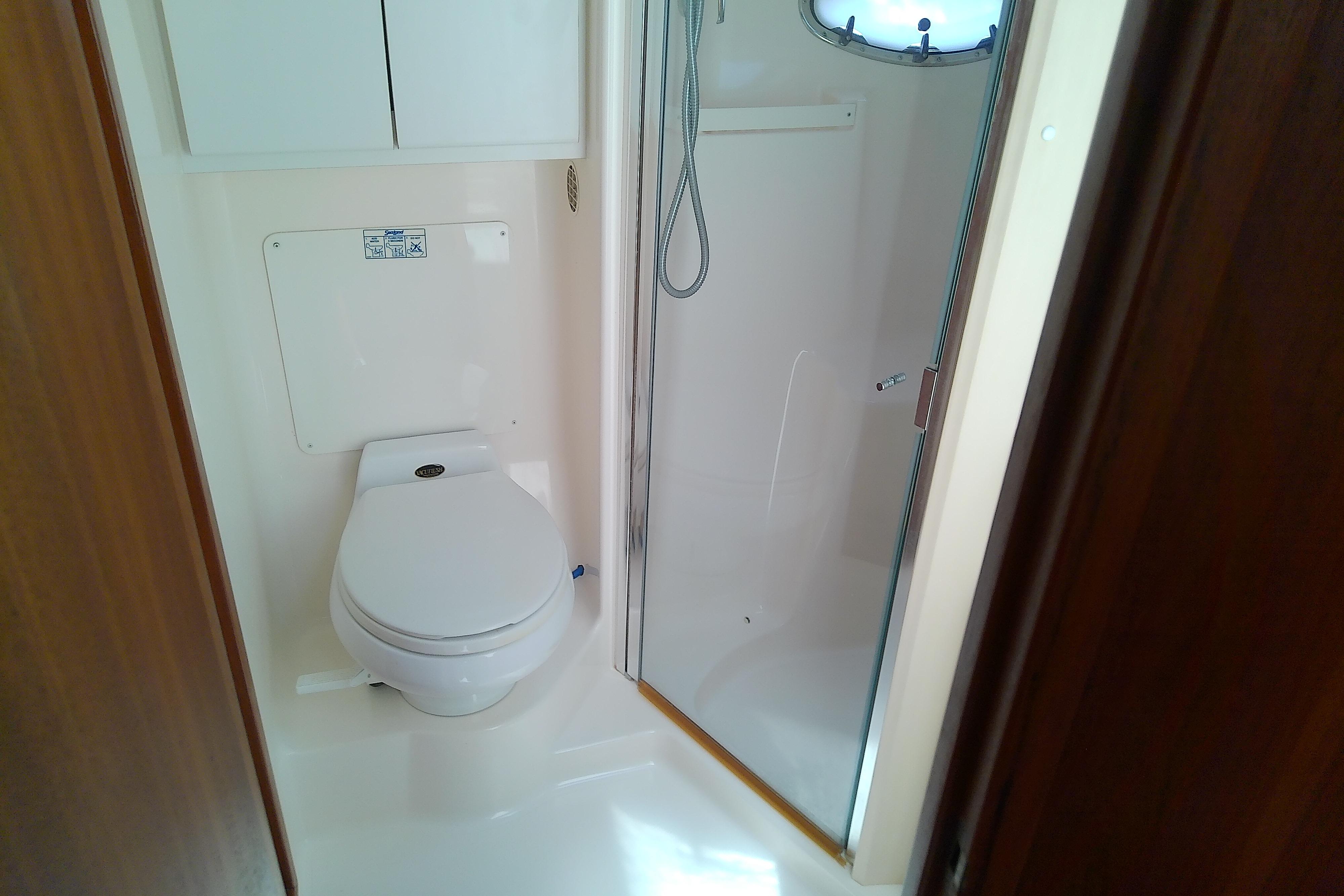 Bathroom interior of 2000 Tiara Yachts 4100 Open with toilet and shower.