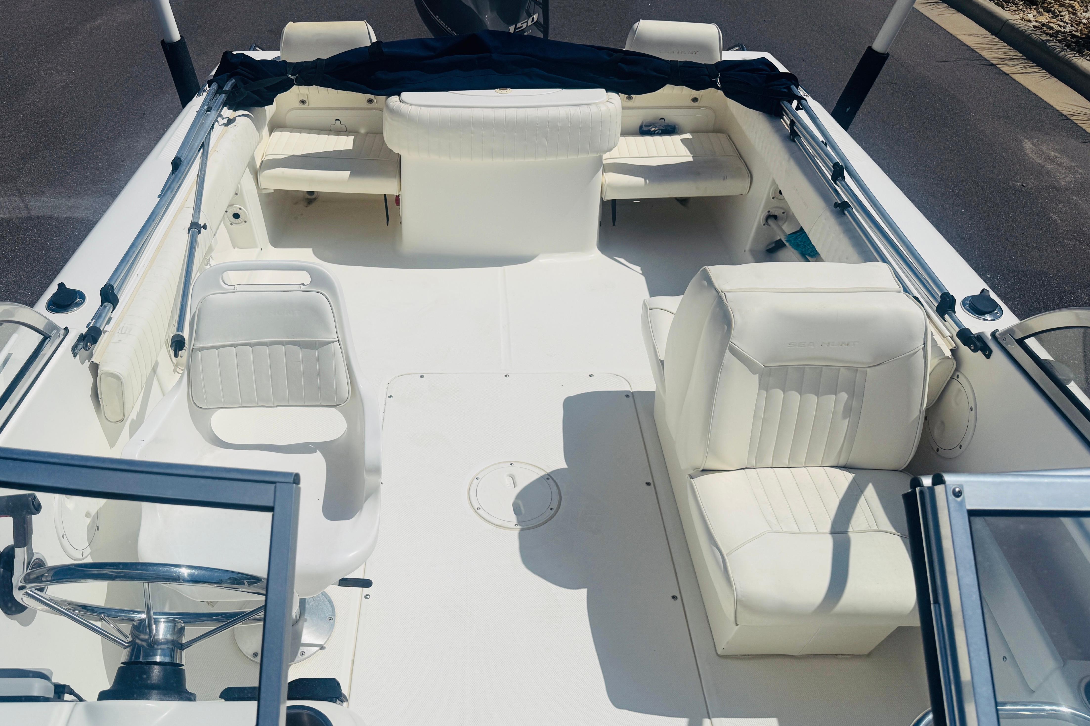 2006 Sea Hunt Escape 200 boat interior with white seating and steering wheel.