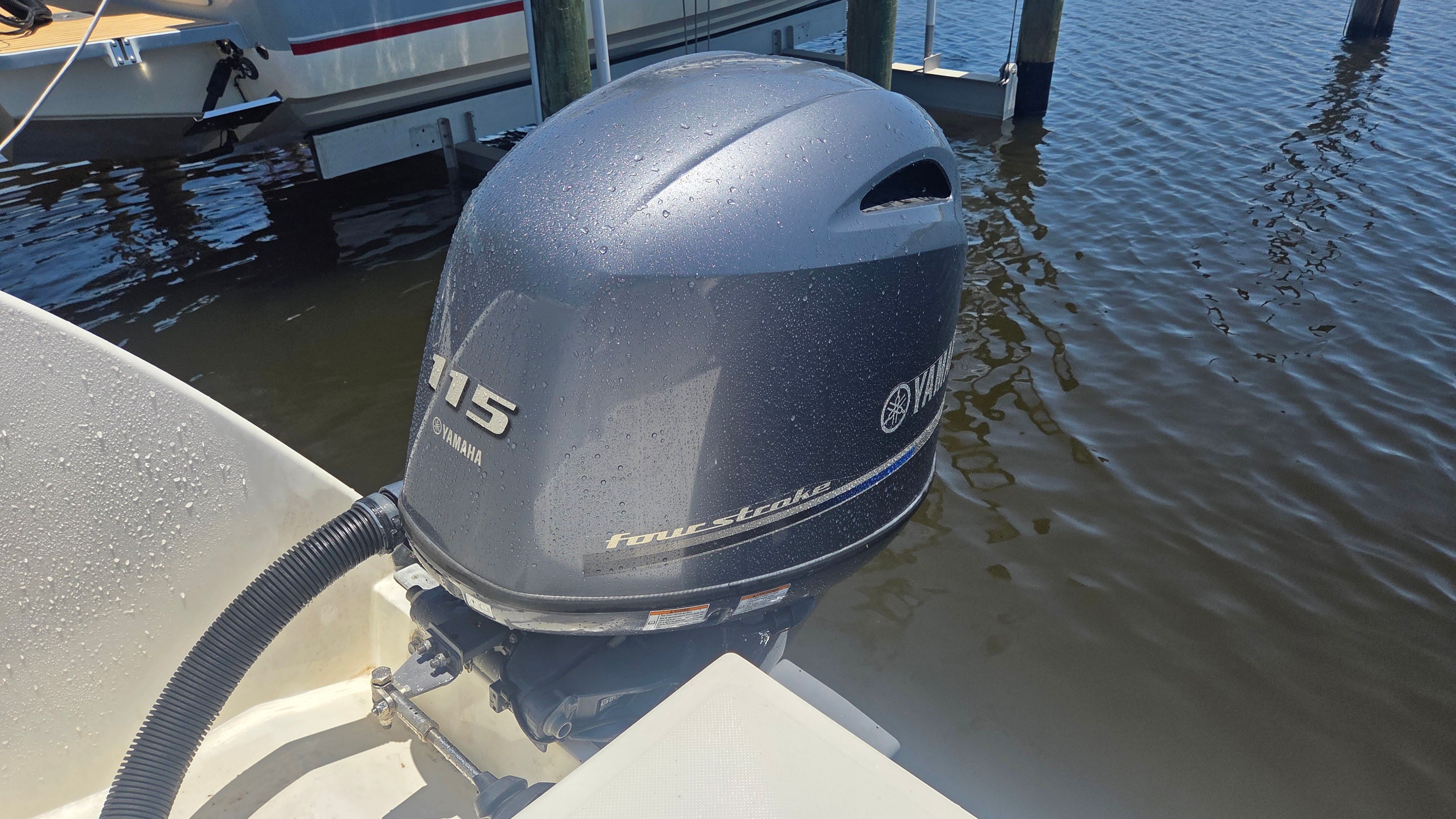 A Yamaha 115 horsepower outboard motor on a boat in the water.