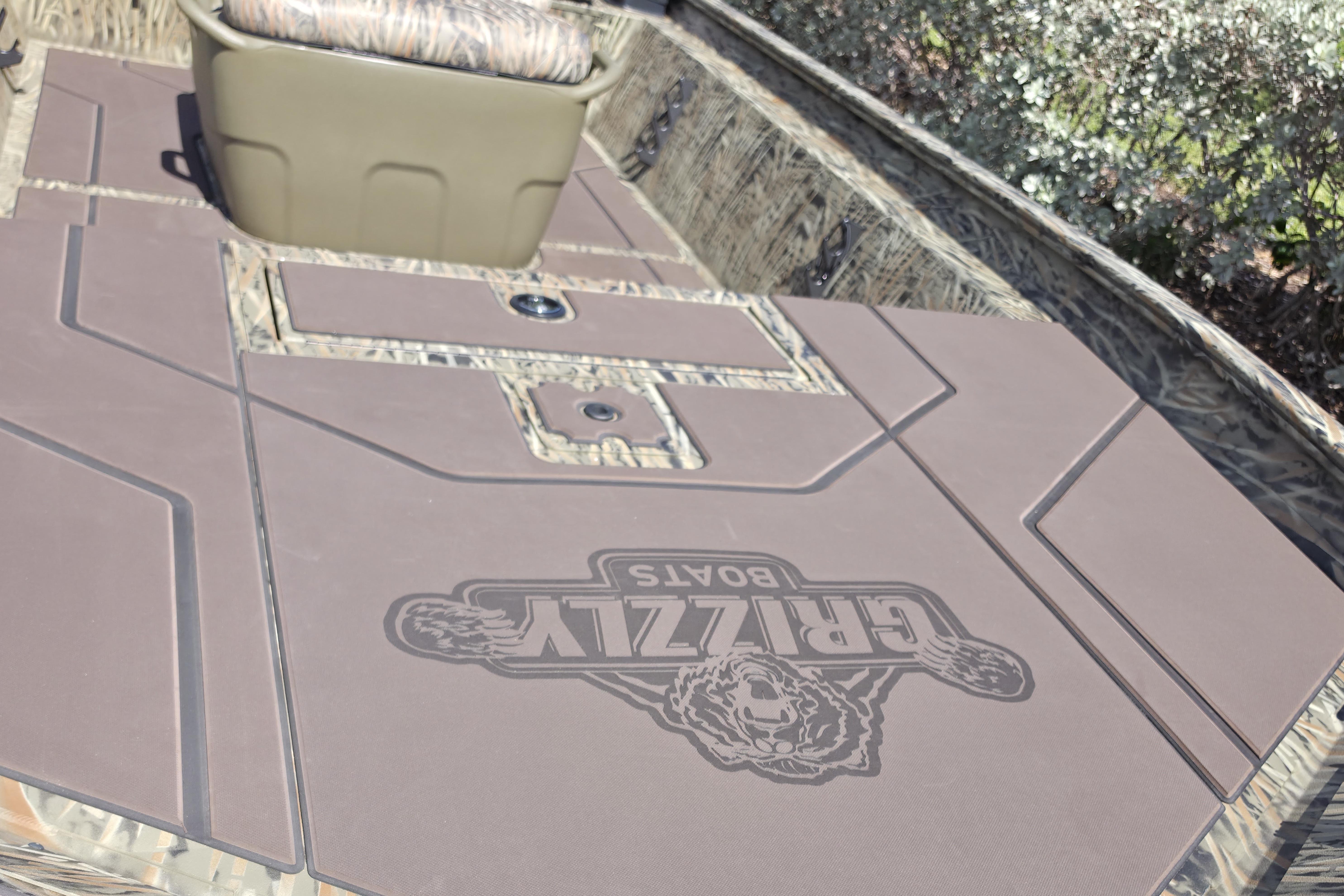 2026 Tracker Grizzly 1860 CC boat interior with camo seating and logo detail.