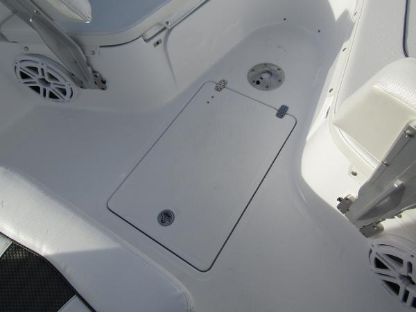 2025 Wellcraft 243 Fisherman boat interior, featuring a clean, white deck with storage hatch.
