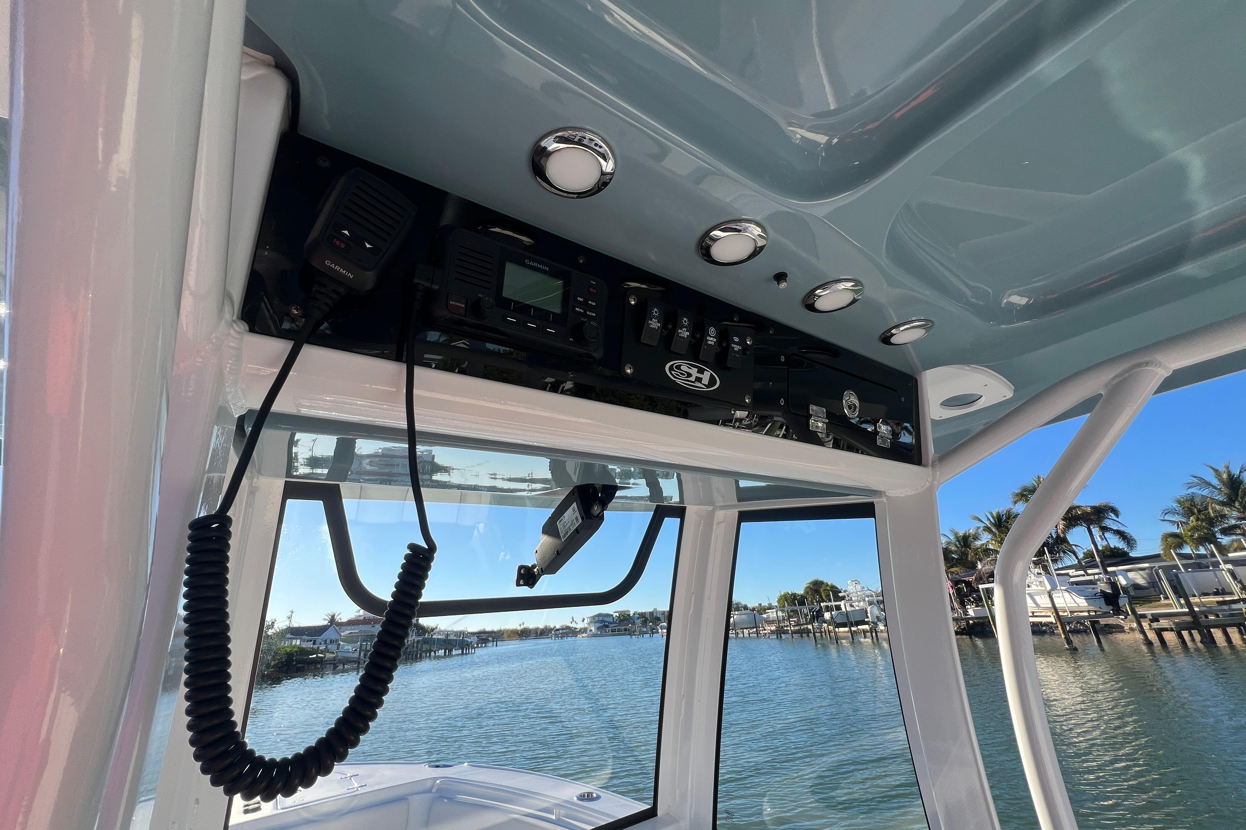 2022 Sea Hunt Ultra 265 SE boat console with electronics and scenic marina view.