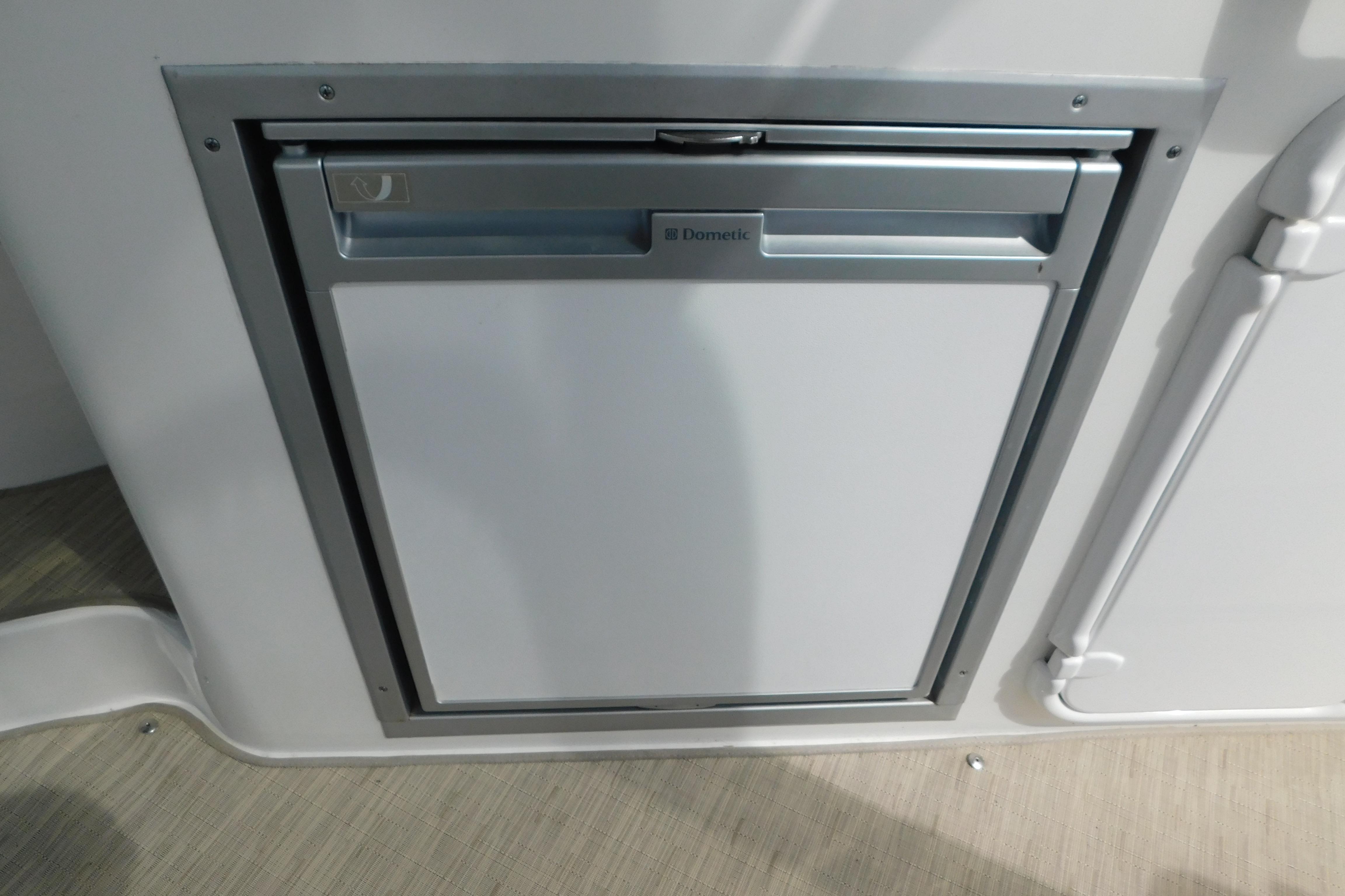 Built-in Dometic refrigerator on 2017 Rinker EX 320 boat interior.