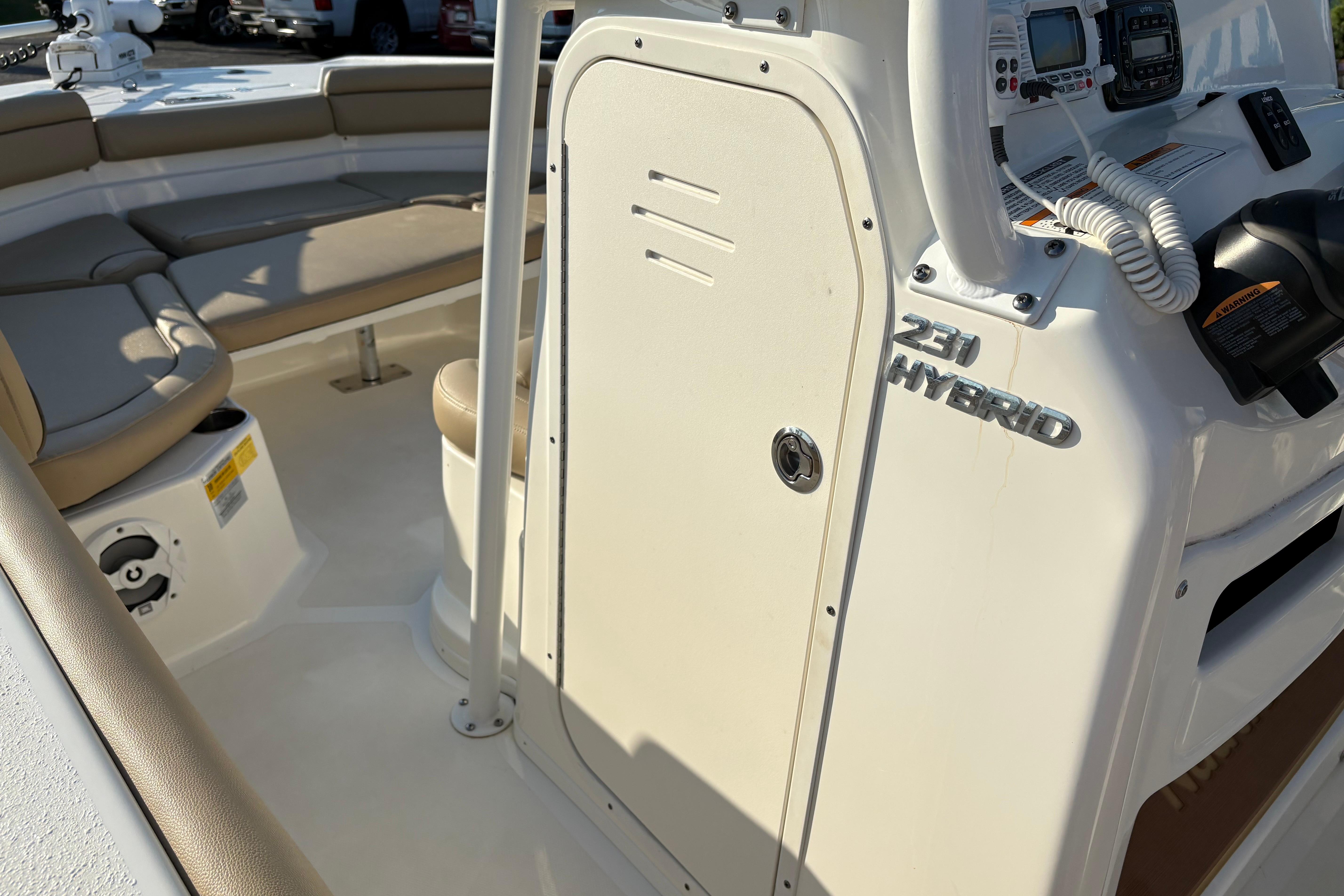 2019 NauticStar 231 Hybrid boat interior with seating and control panel.