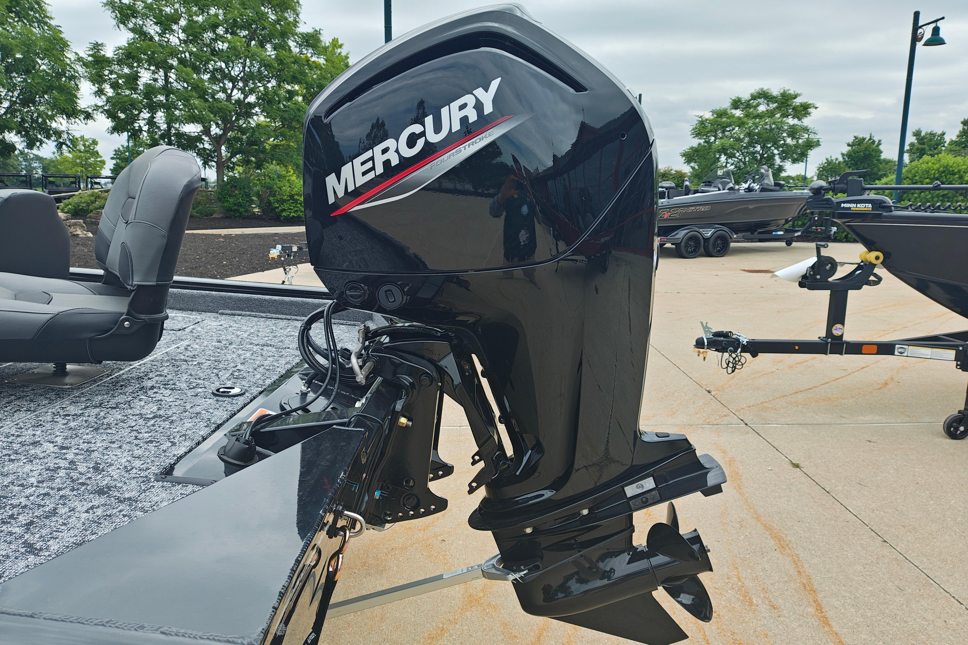 2026 Tracker Pro Team 175 boat with Mercury outboard motor, parked on concrete.