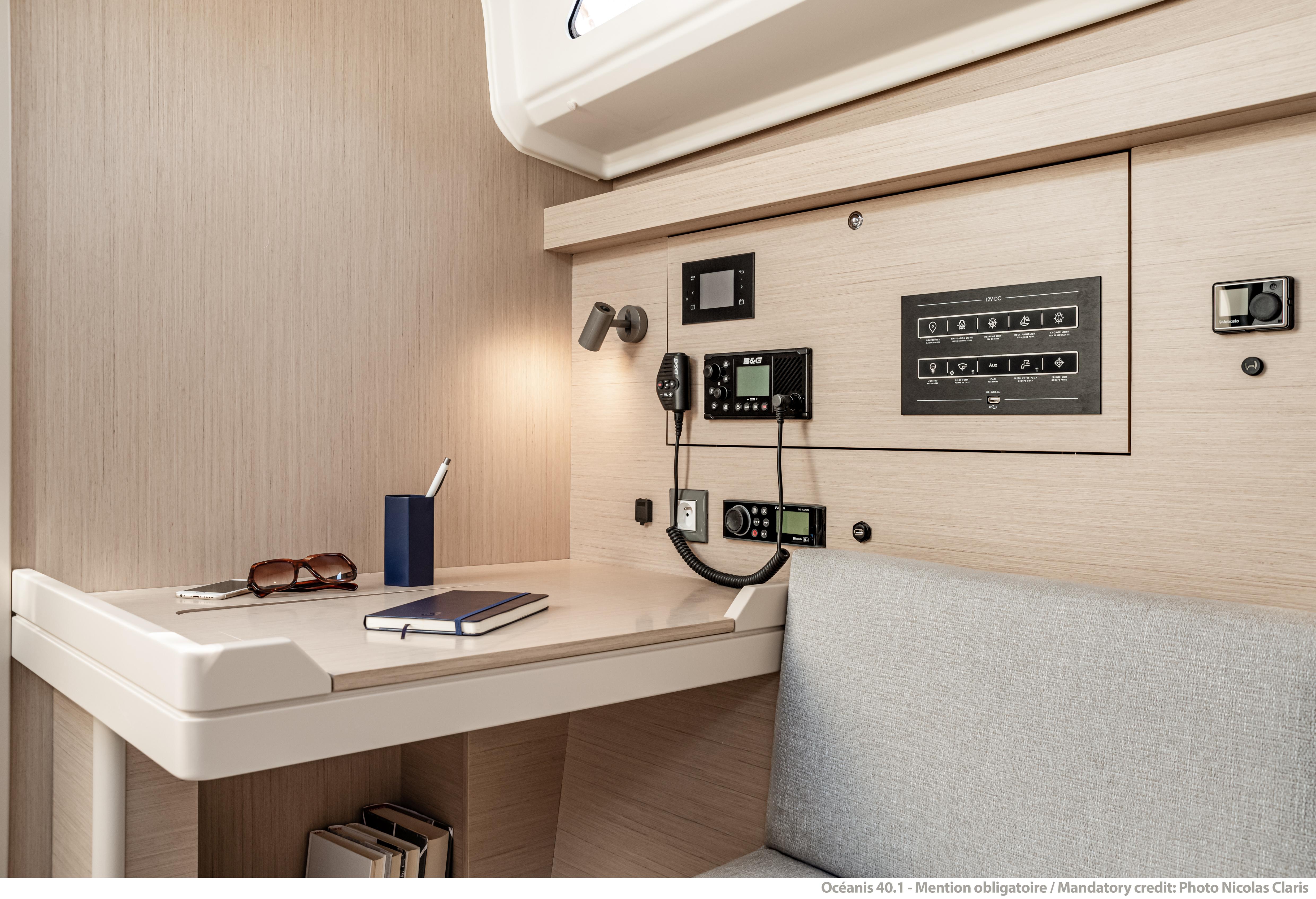 2025 Beneteau Oceanis 40.1 yacht interior with navigation panel and desk area.