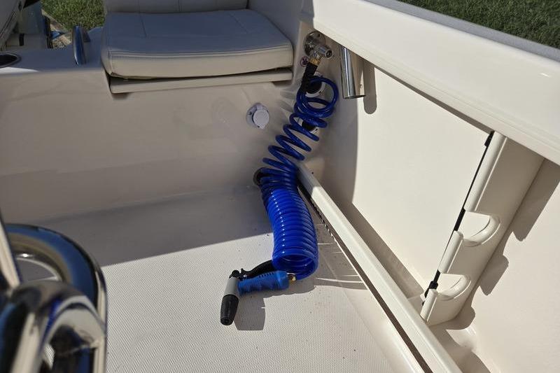 2026 Grady-White Fisherman 180 boat interior with blue coiled hose and seating.