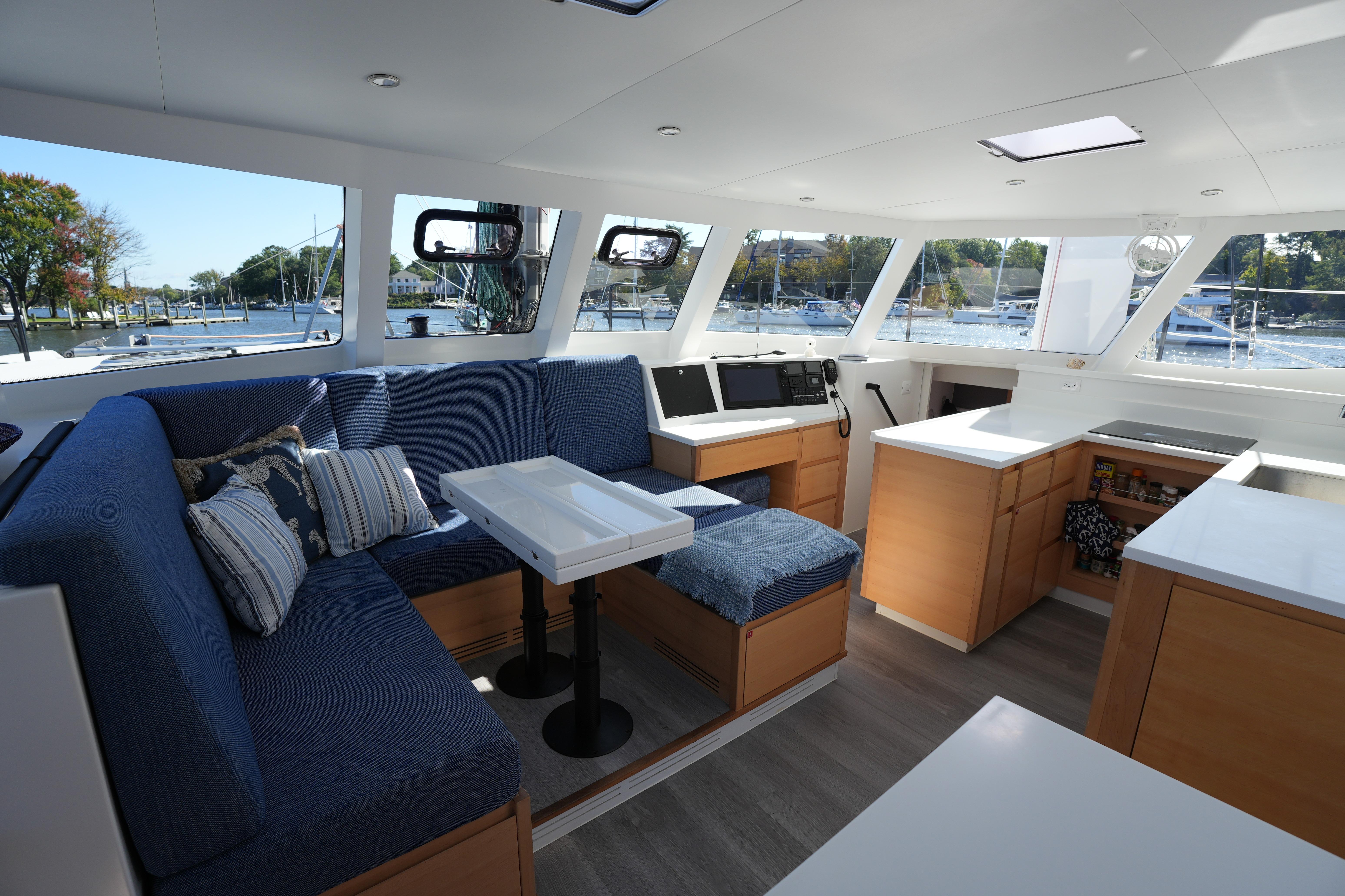 Luxurious interior of 2024 Balance 442 yacht with modern seating and navigation area.