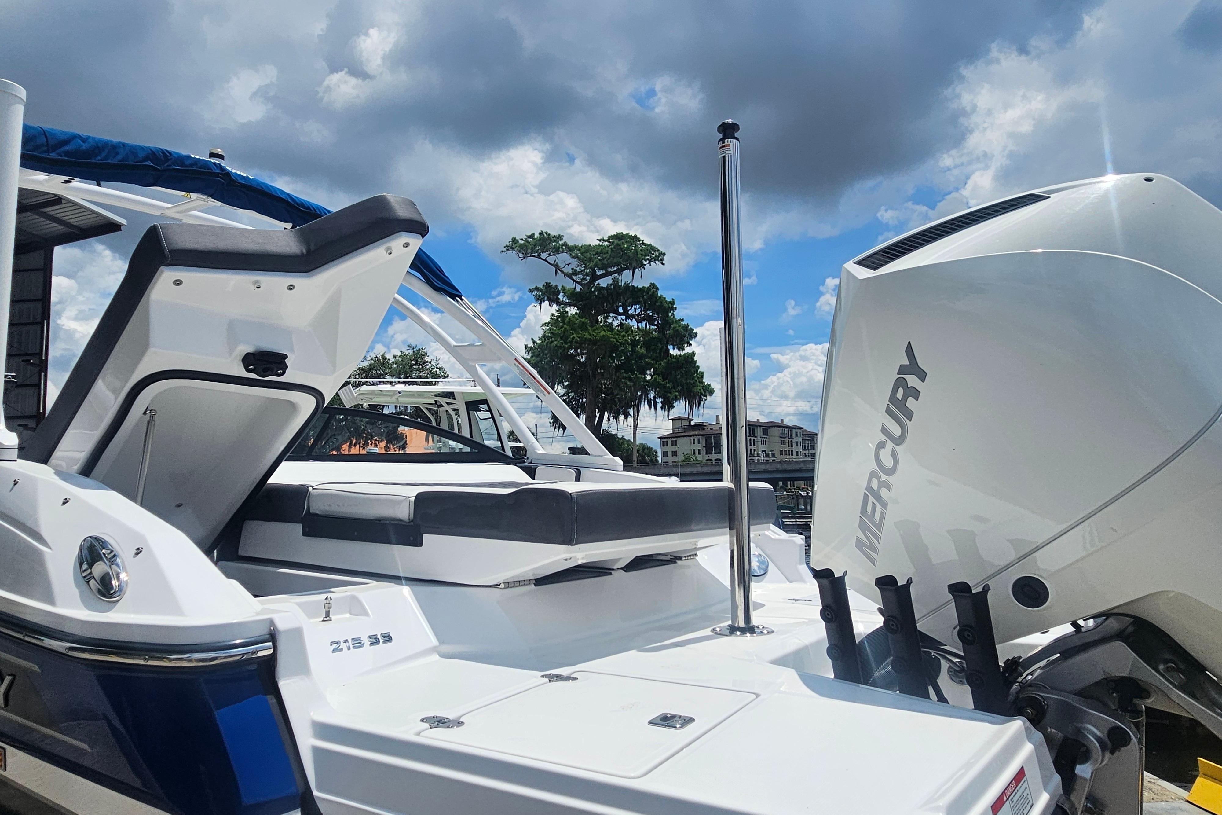 2024 Monterey 215SS Super Sport boat with Mercury engine, docked under a cloudy sky.