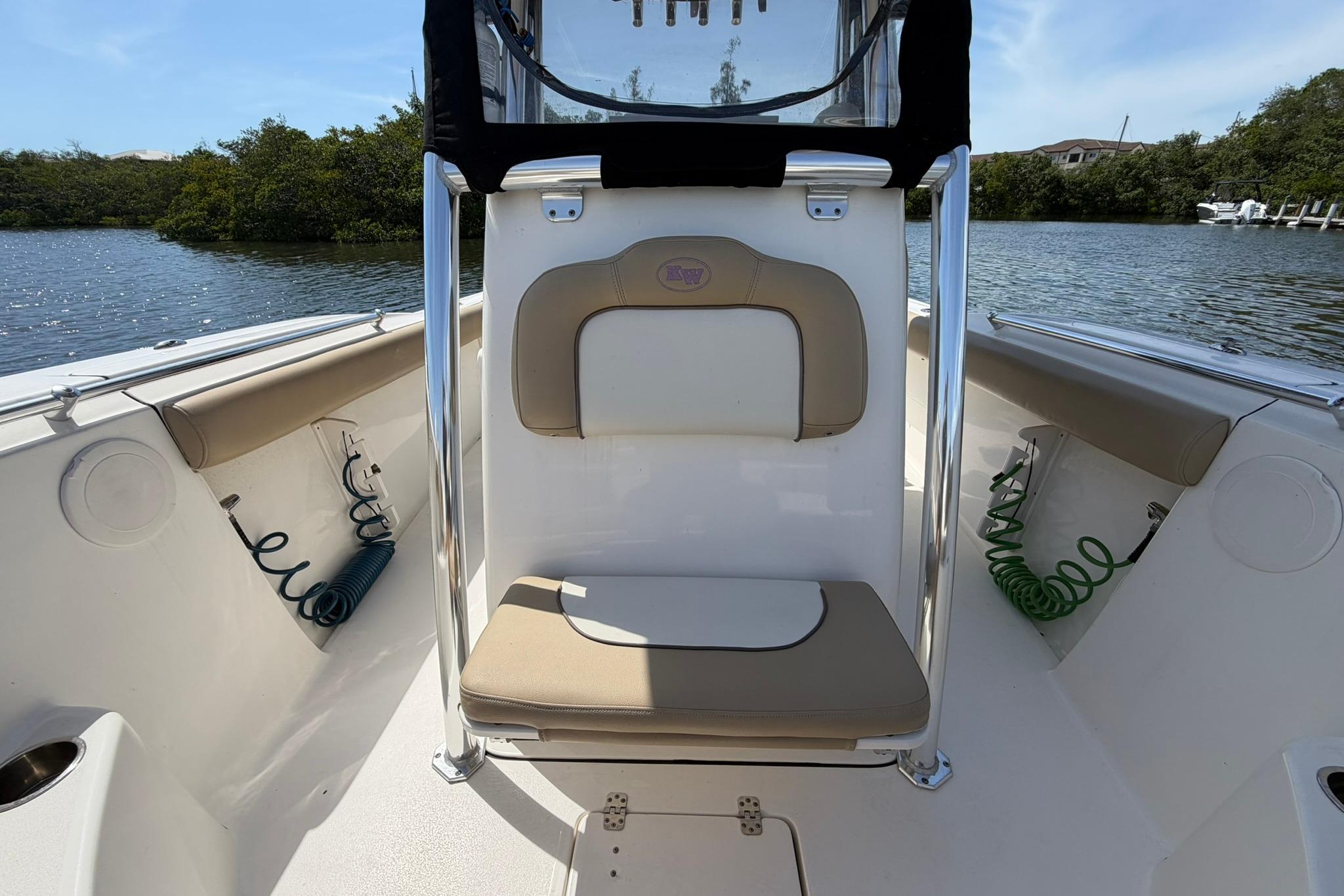 2019 Key West 244 Center Console boat interior with seating, on a calm waterway.
