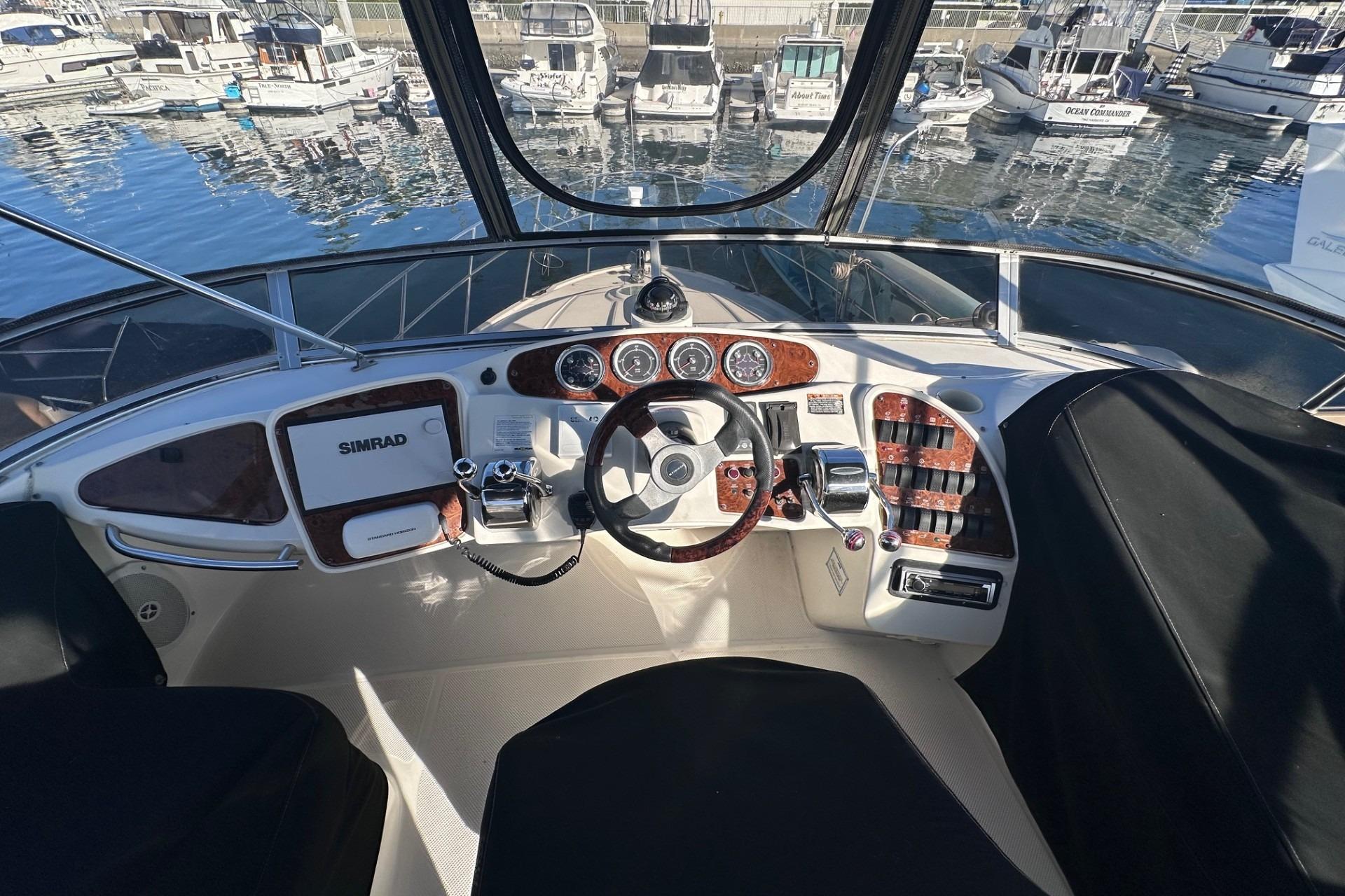 2004 Meridian 459 Motoryacht helm with navigation equipment and marina view.