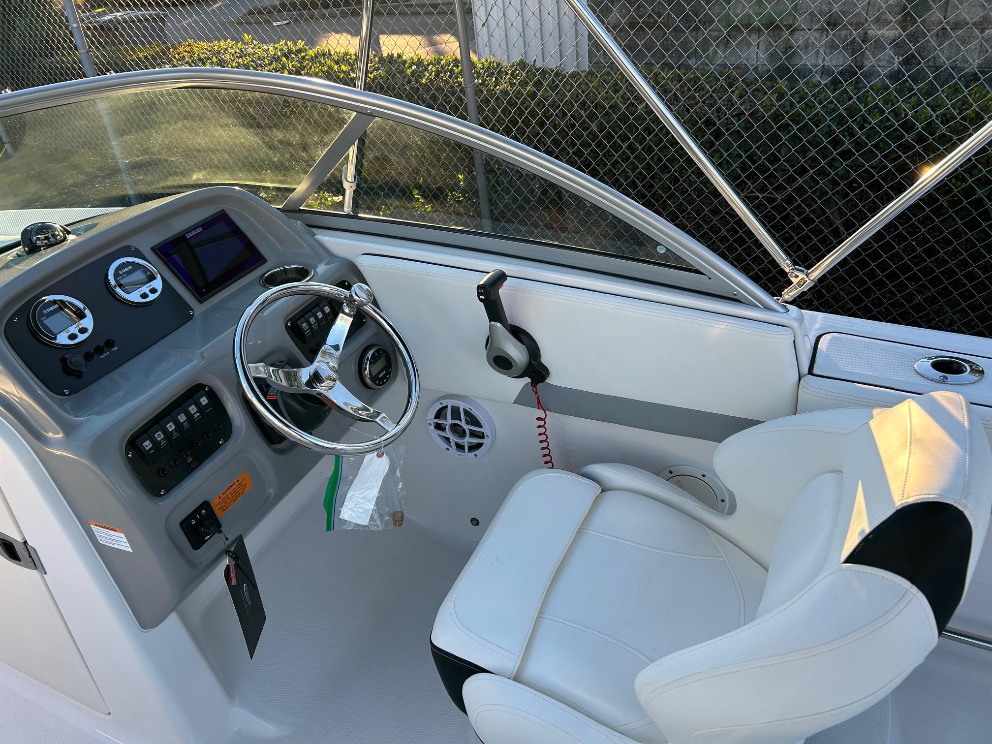 2026 Robalo R207 Dual Console boat interior with steering wheel and dashboard controls.