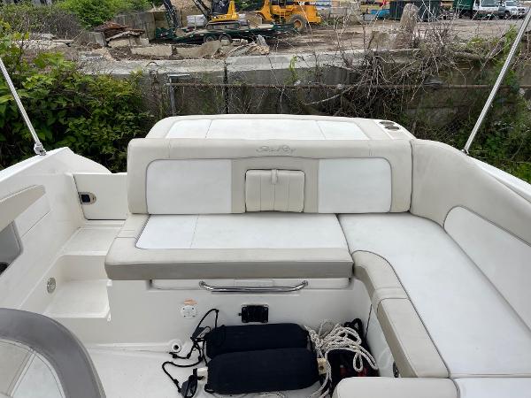 2013 Sea Ray 240 Sundeck boat interior with white seating and storage compartments.