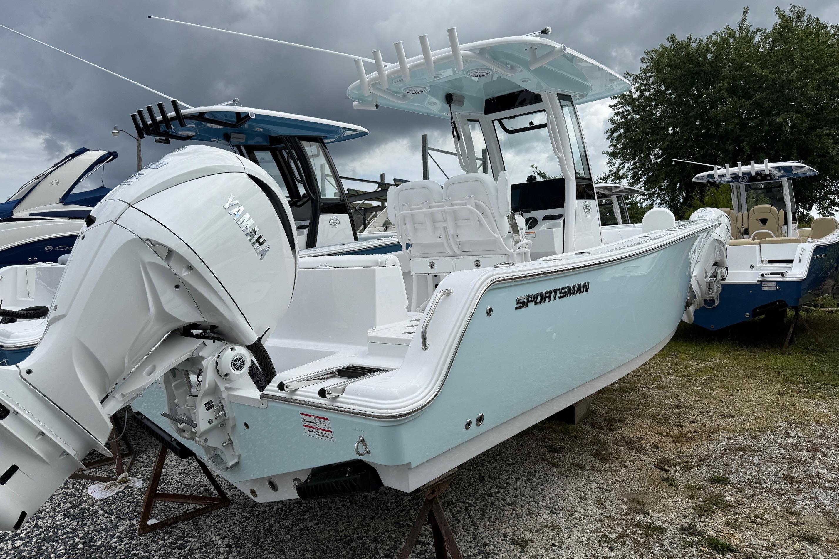 2026 Sportsman Heritage 231 Center Console boat with Yamaha engine, parked outdoors.
